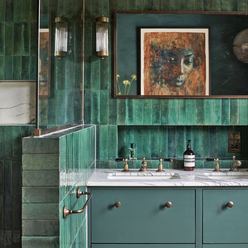 dark green tiled bathroom with double vanity unit and shower to side