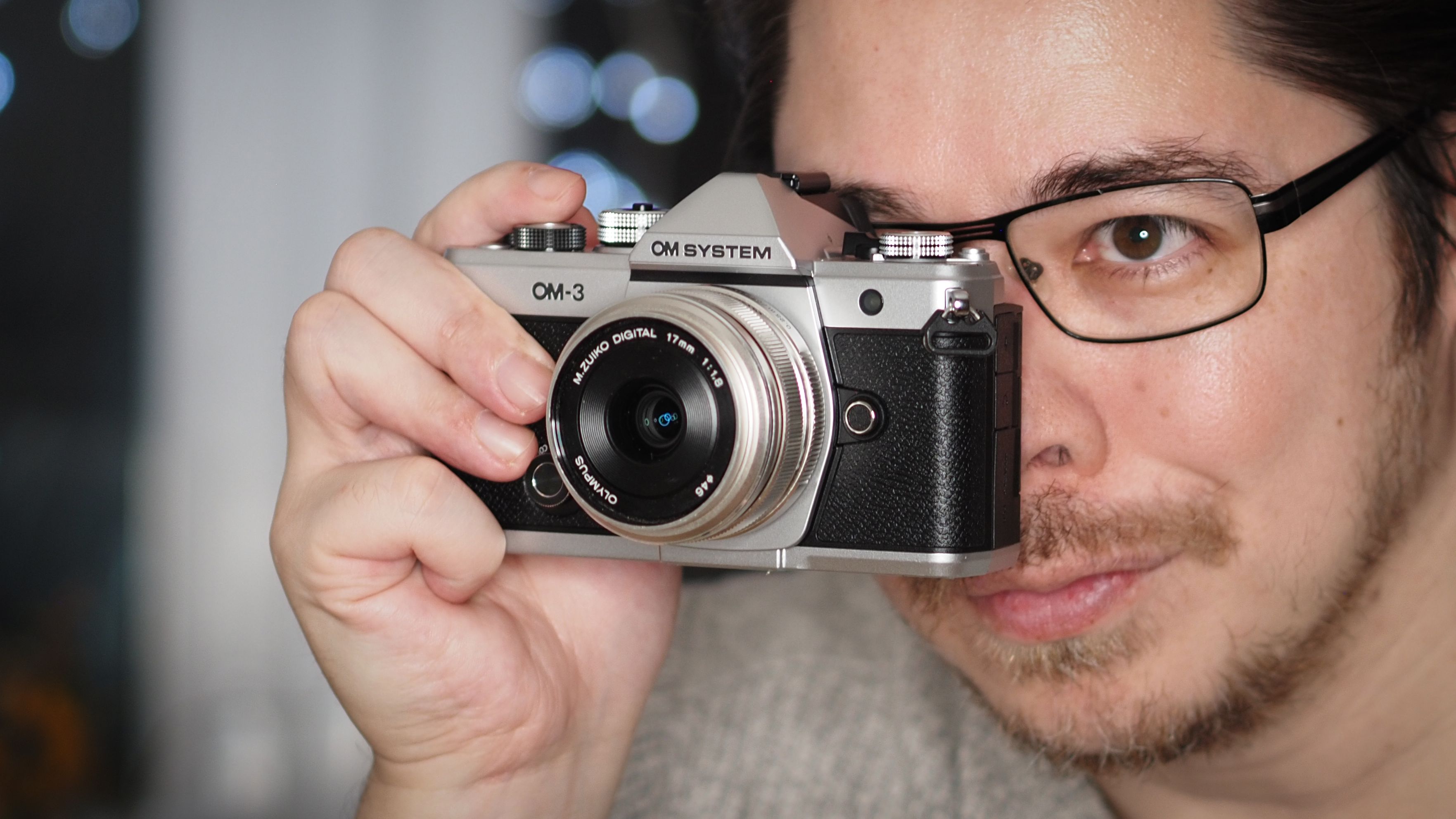 James Artaius holding an OM System OM-3