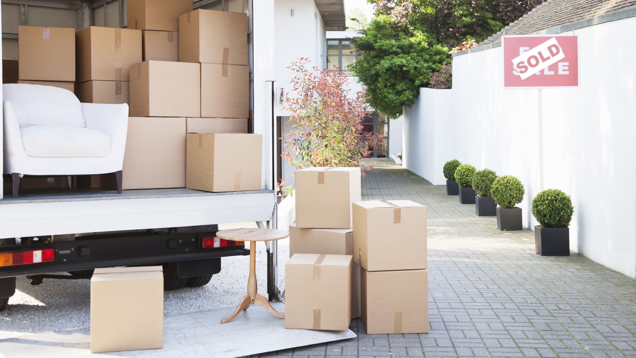 Boxes on ground near moving van