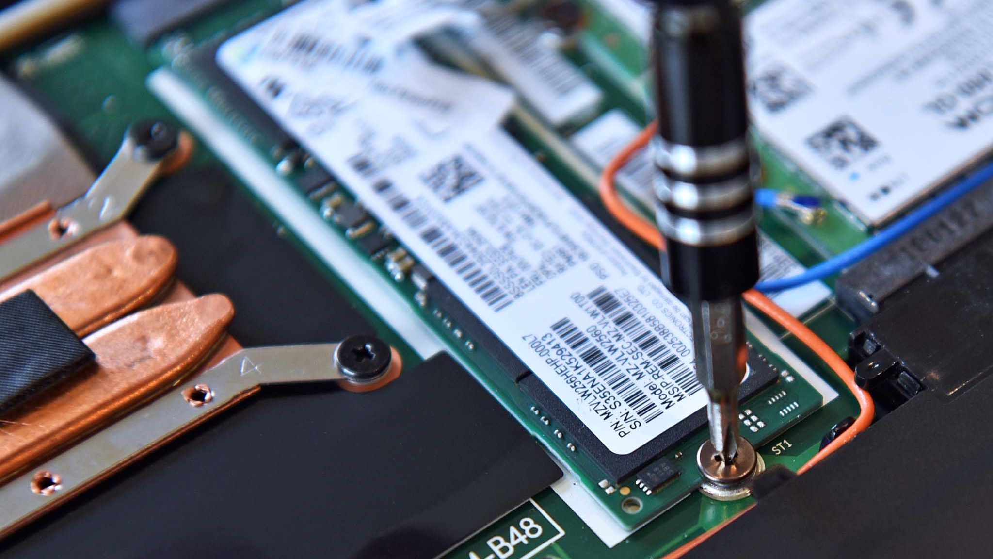 Screwing an M.2 SSD into a Lenovo ThinkPad X1 Carbon laptop