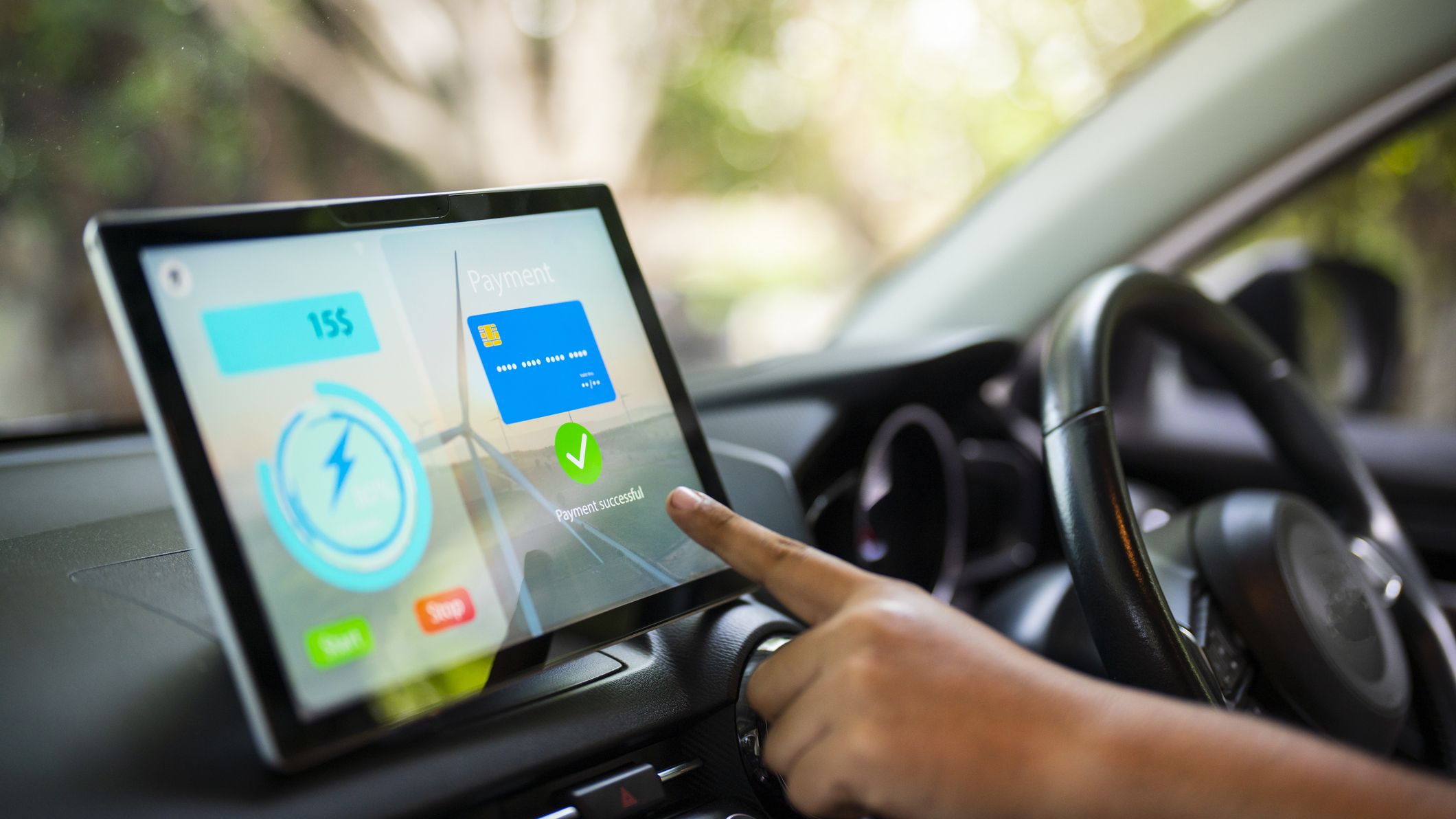 A person using the infotainment system inside of a car.