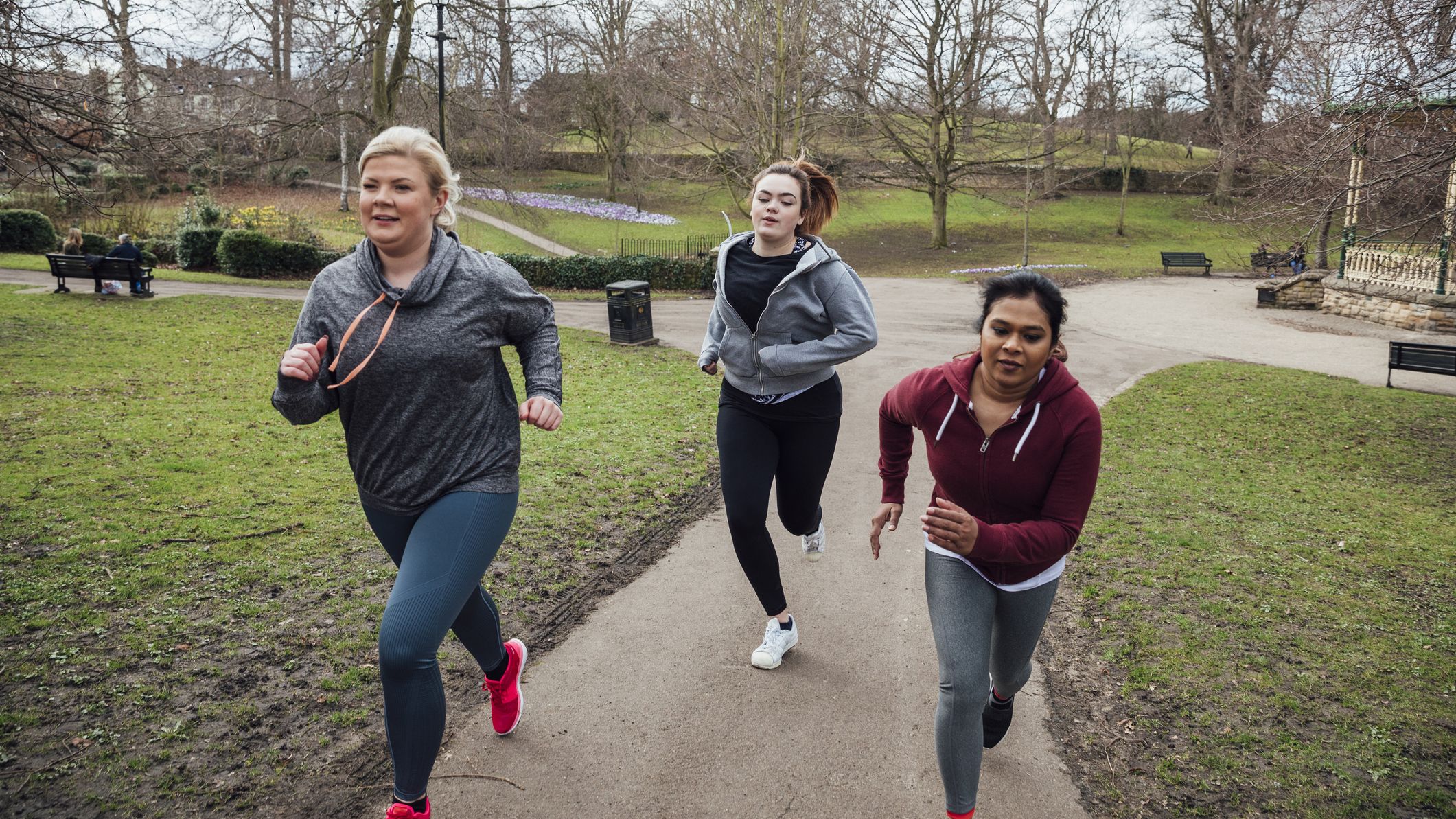 Three women running up a hill