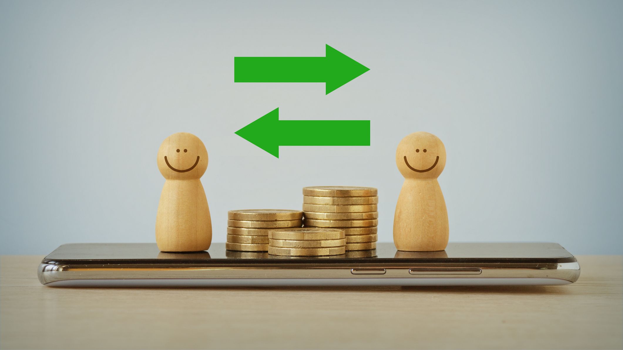 two sculptures depicting people with a stack of coins between them and green arrows points to each one, signaling a money transfer