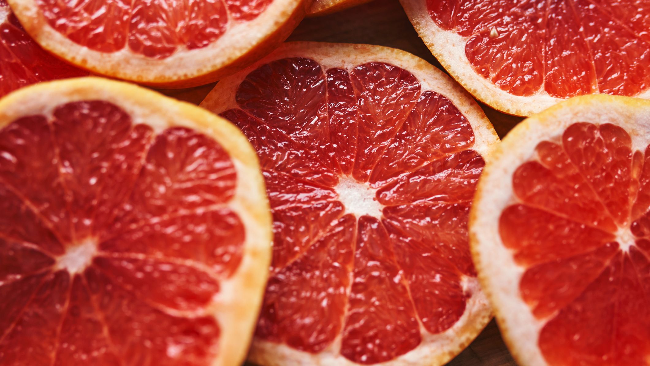 Freshly cut grapefruit slices displaying vibrant red hues