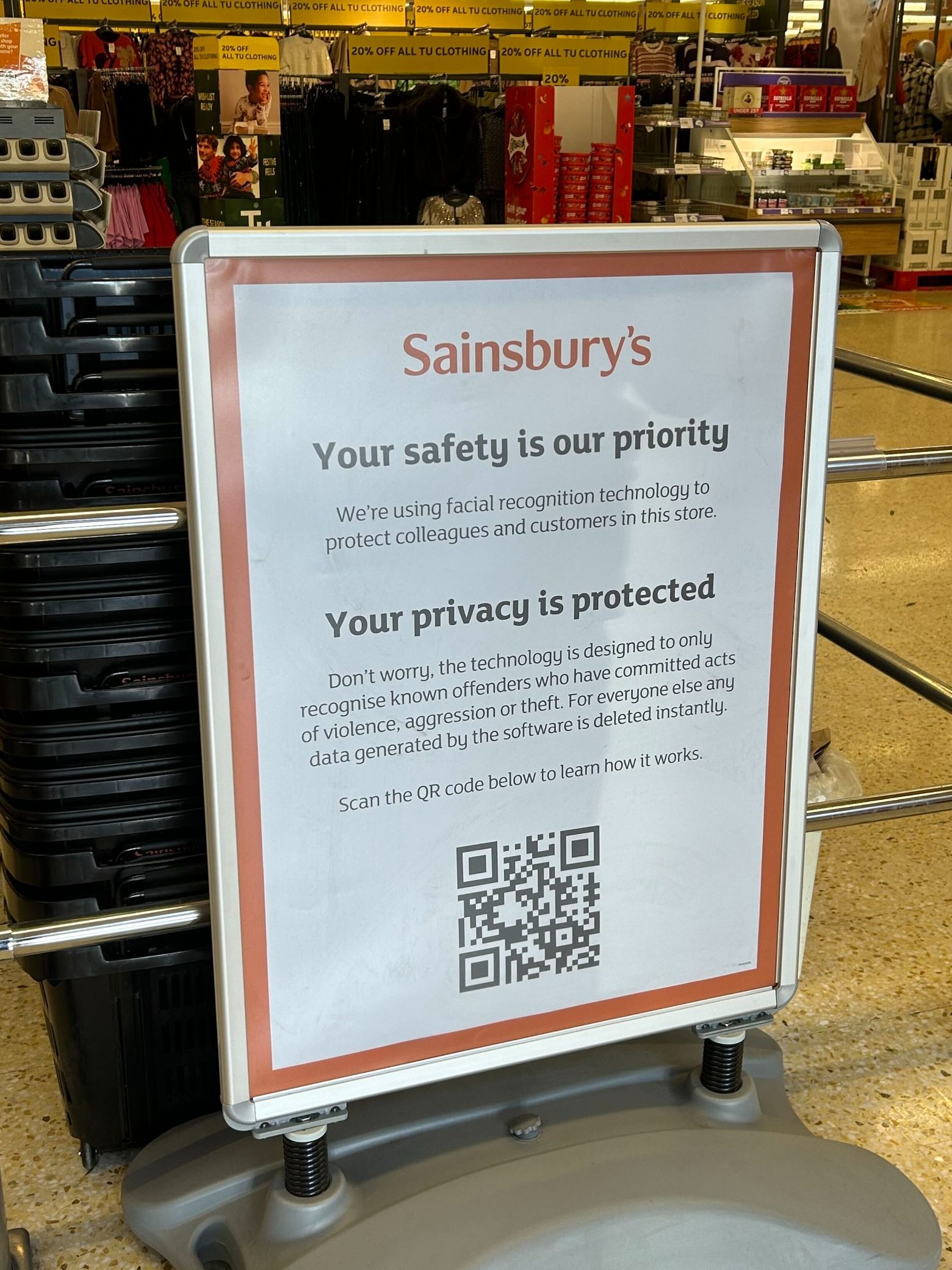 An in-store Sainsbury's sign explaining live facial recognition technology and privacy terms.