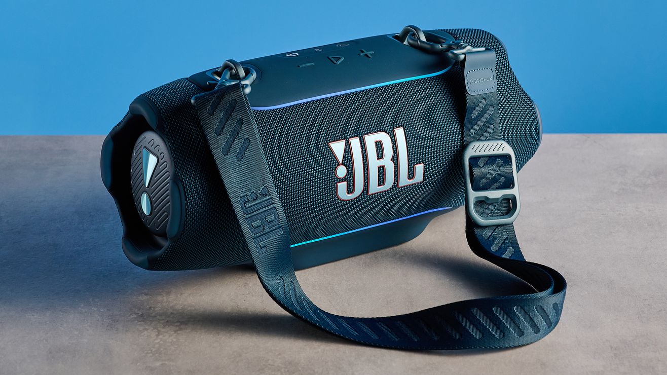 the JBL Xtreme 5 bluetooth speaker in blue shown with the rugged carry strap and buttons