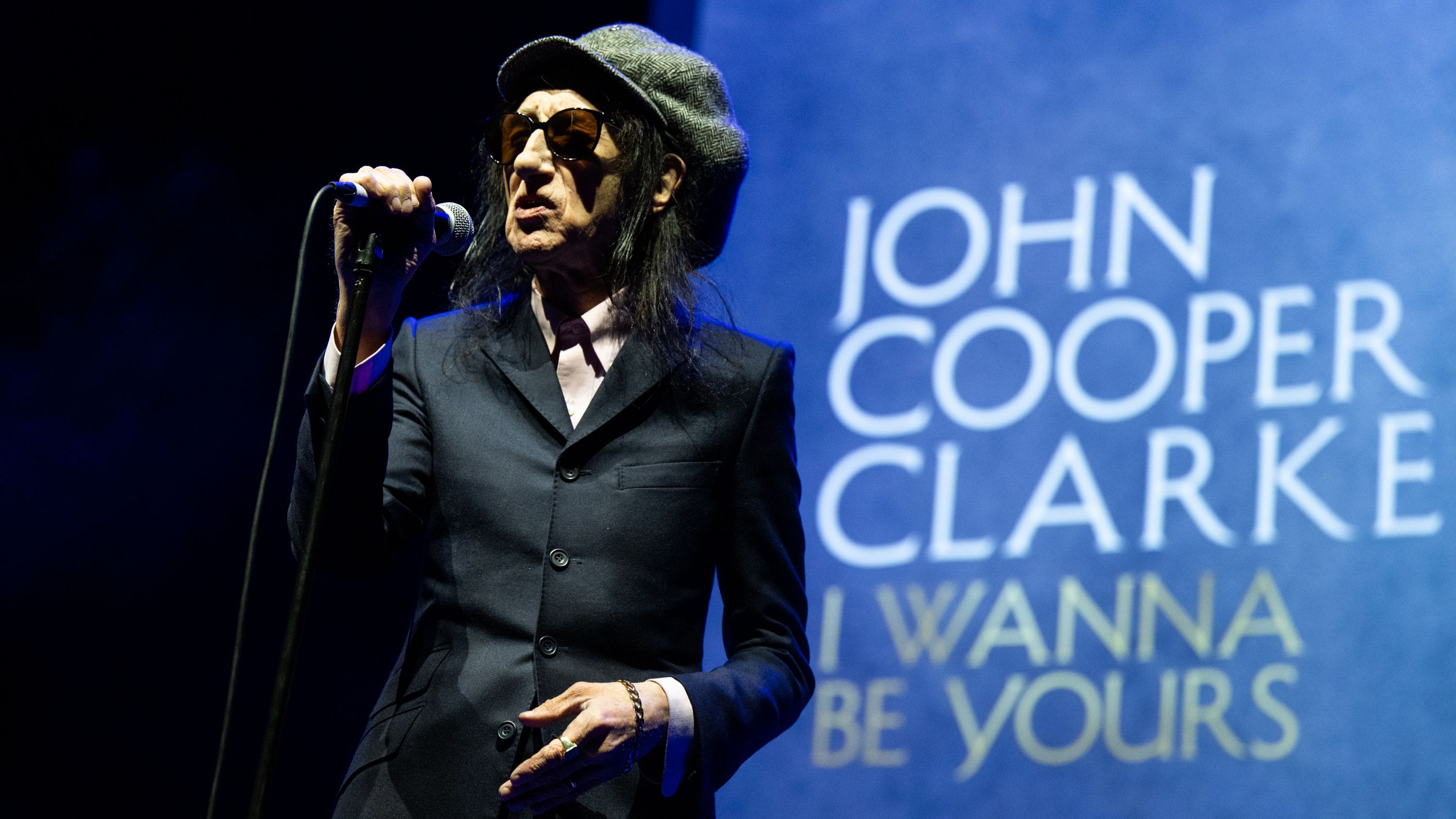 LONDON, ENGLAND - APRIL 08: (EDITORIAL USE ONLY IN MAGAZINES AND NEWSPAPERS. NO OTHER USE PERMITTED) John Cooper Clarke performs live at Eventim Apollo on April 08, 2022 in London, England. (Photo by Samir Hussein/WireImage)
