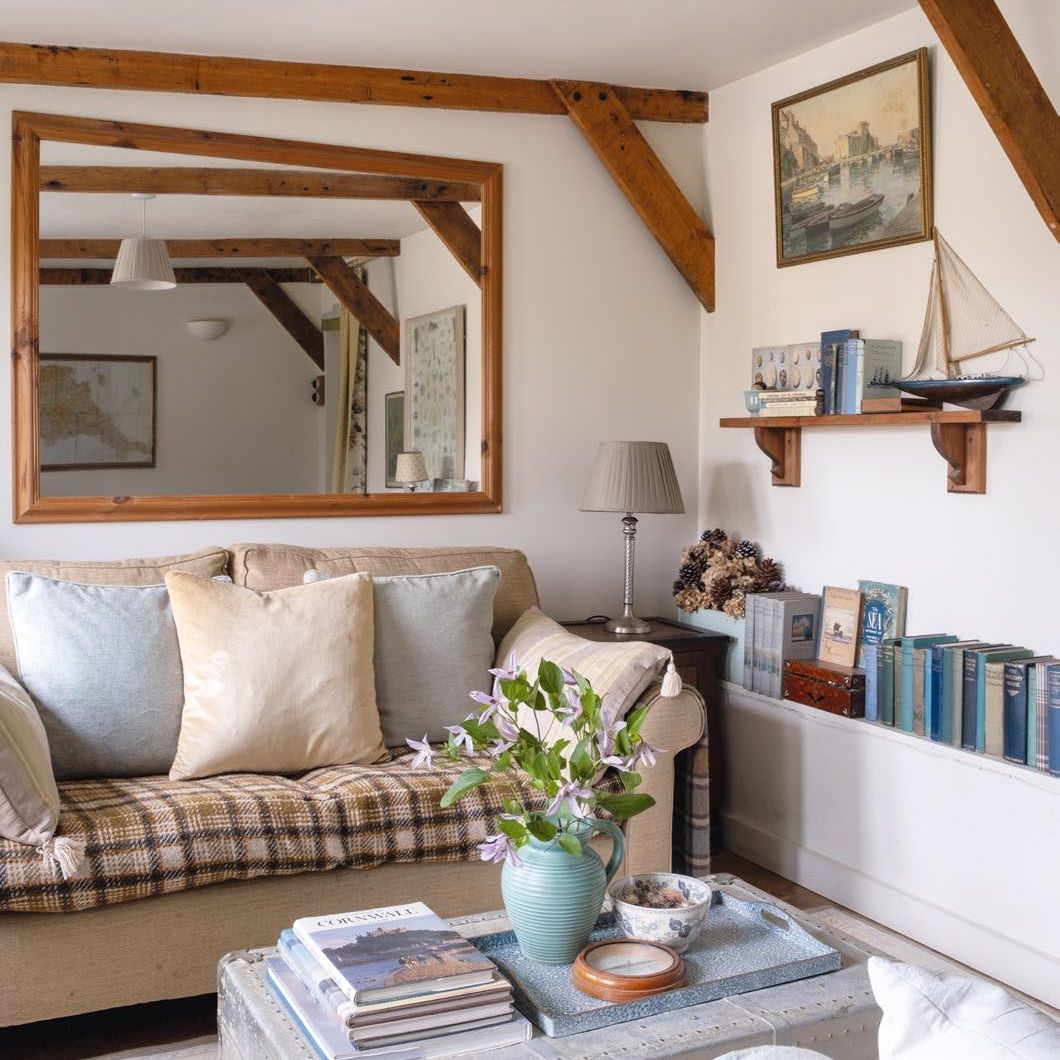 Snug decorated in neutral tones with ceiling beams and large mirror