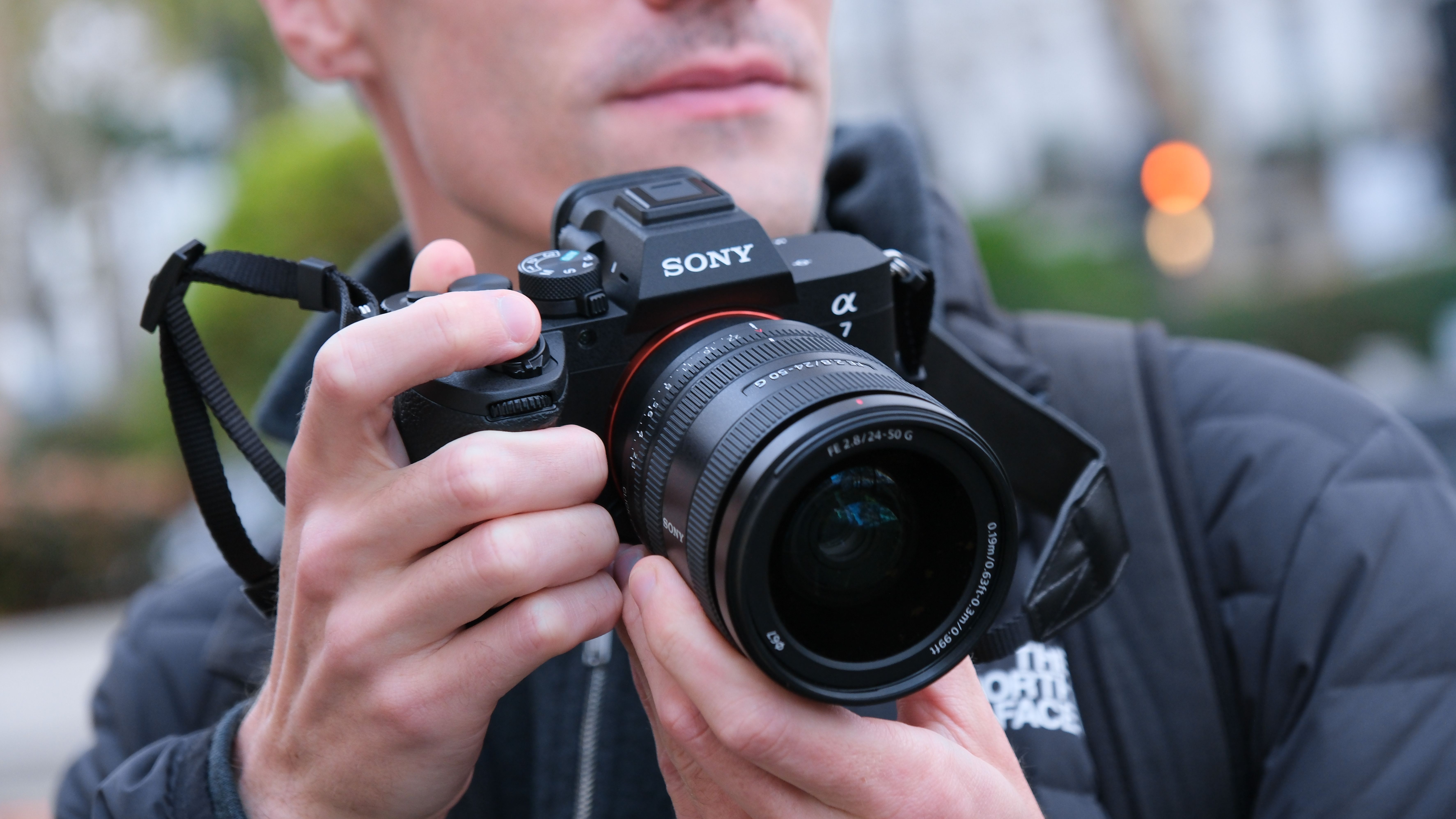 Sony A7 V camera held in a person's hands