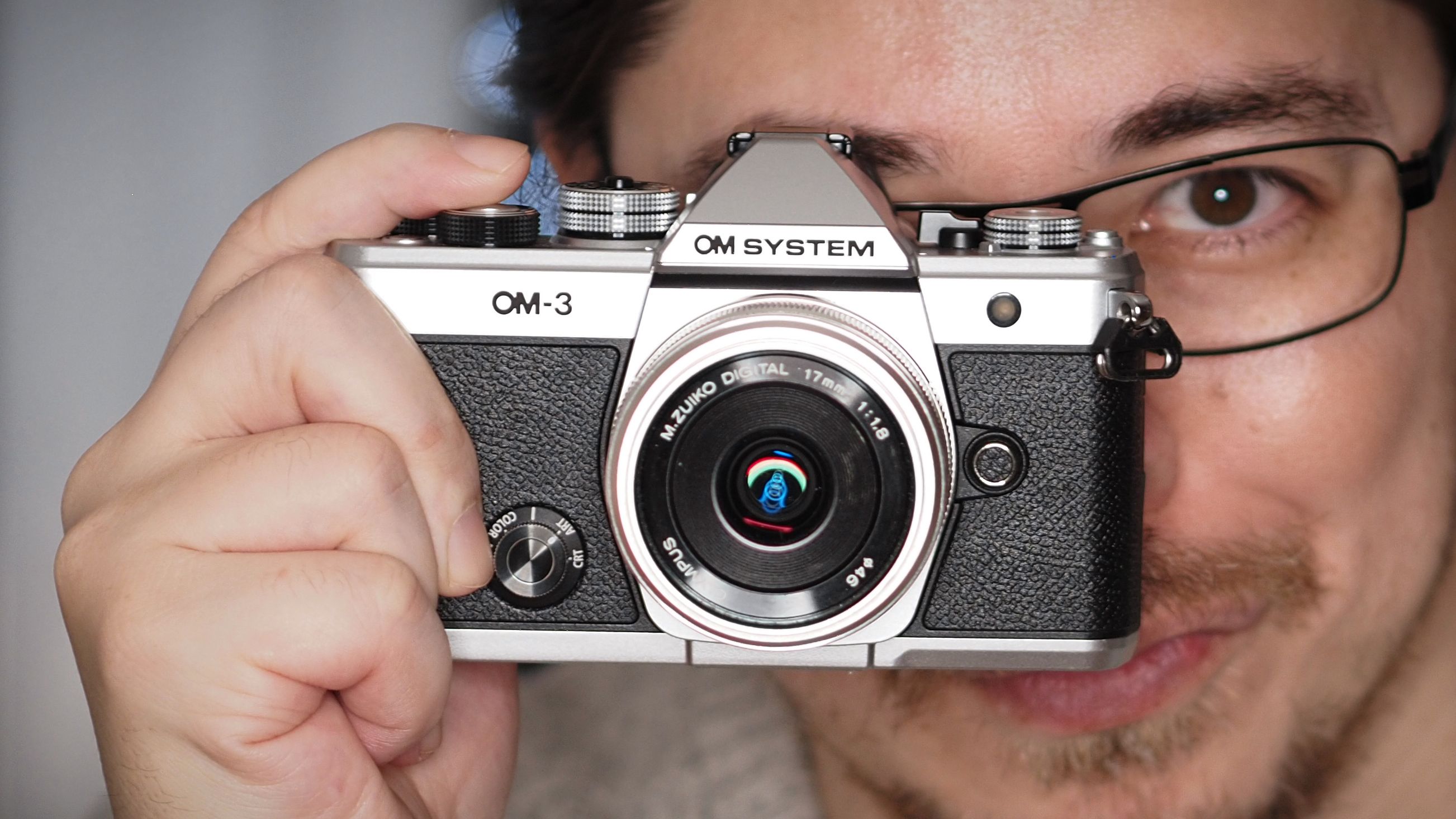 James Artaius holding an OM System OM-3