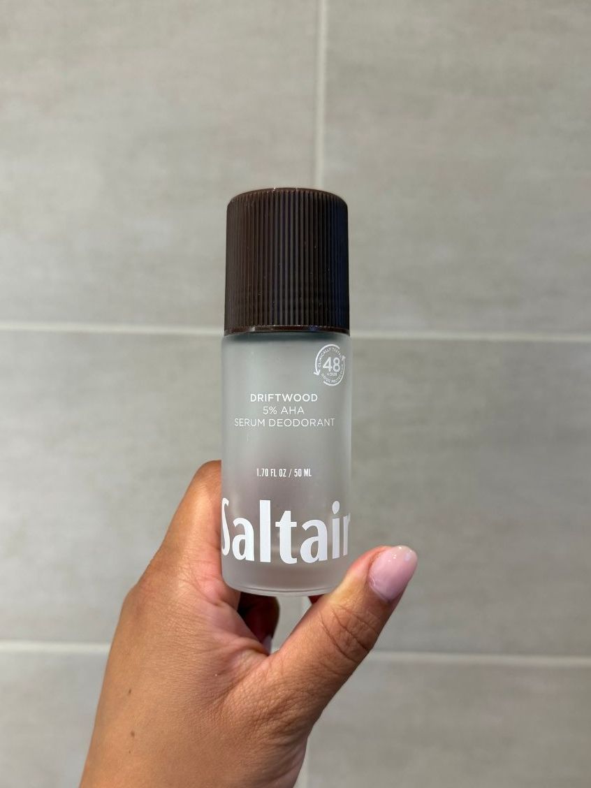 Aleesha holding empty Saltair Driftwood deodorant