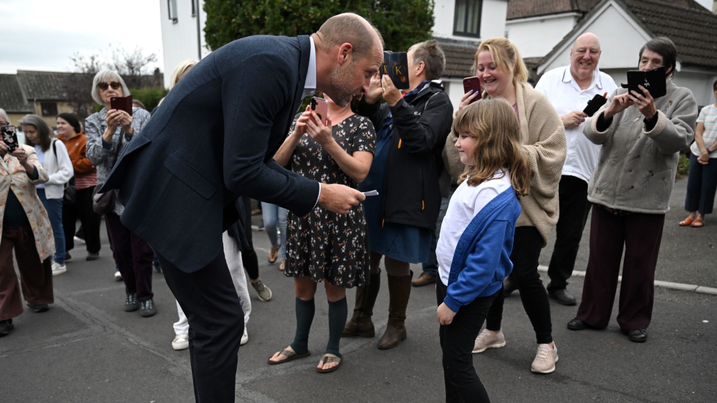 Prince William receives a card for Princess Charlotte from a young school girl during his visit to Ilminster Fire Station on October 06, 2026 in Ilminster, England.