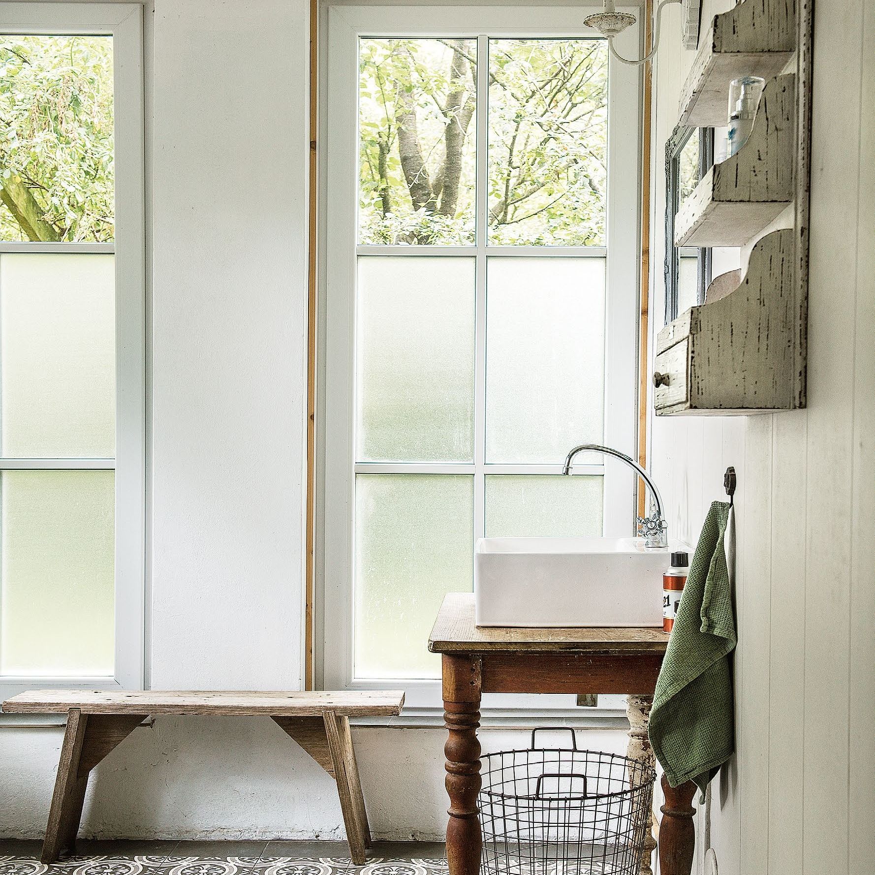 bathroom with large windows and upcycled vintage basin vanity and wooden wall shelving unit