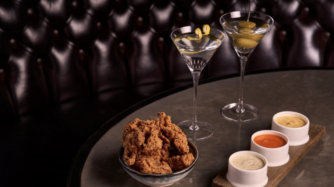 an image of two martinis and some buttermilk fried chicken with a trio of dips on a table at Kerridge's