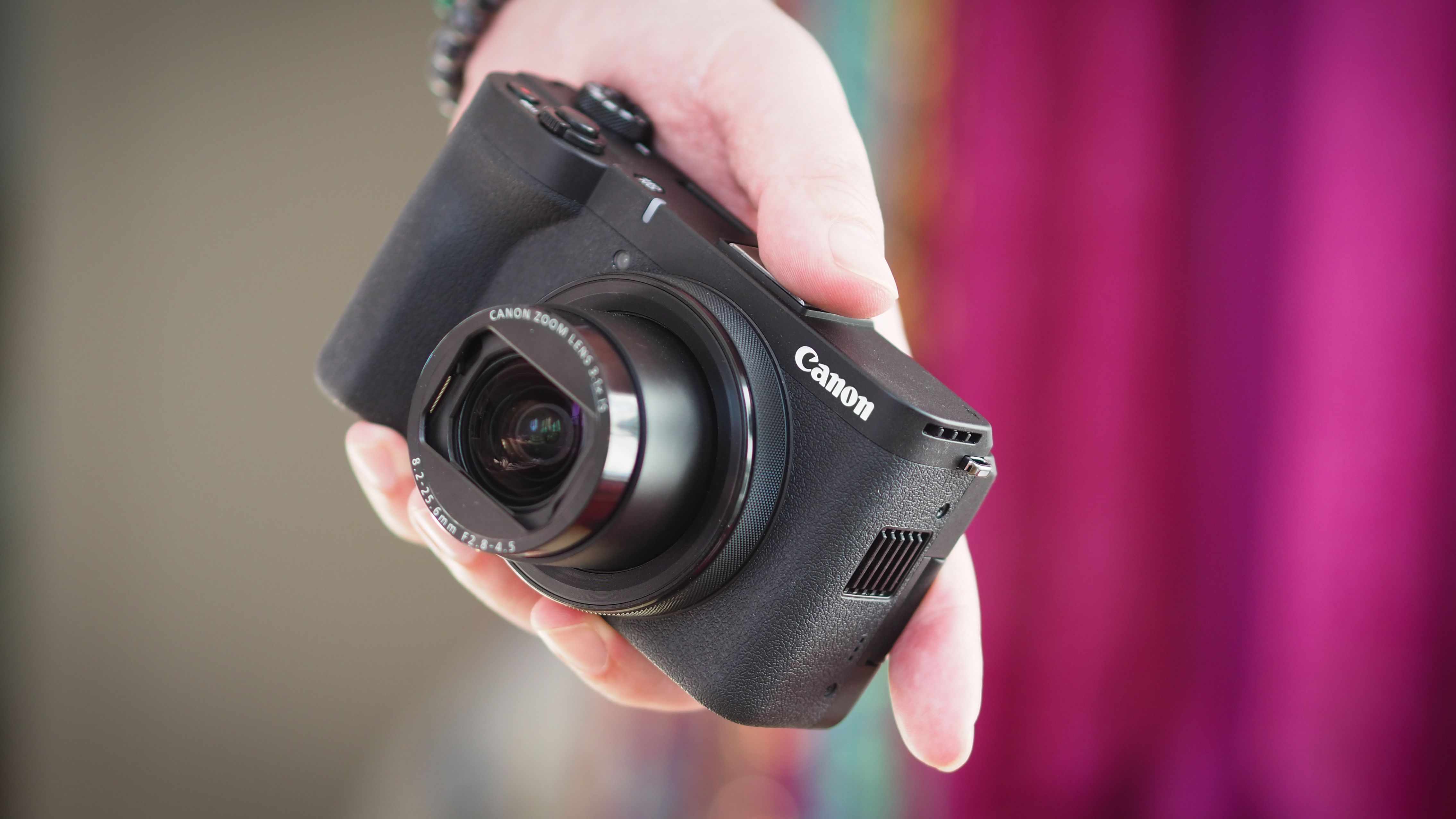 Canon PowerShot V1 in the palm of a photographer's hand