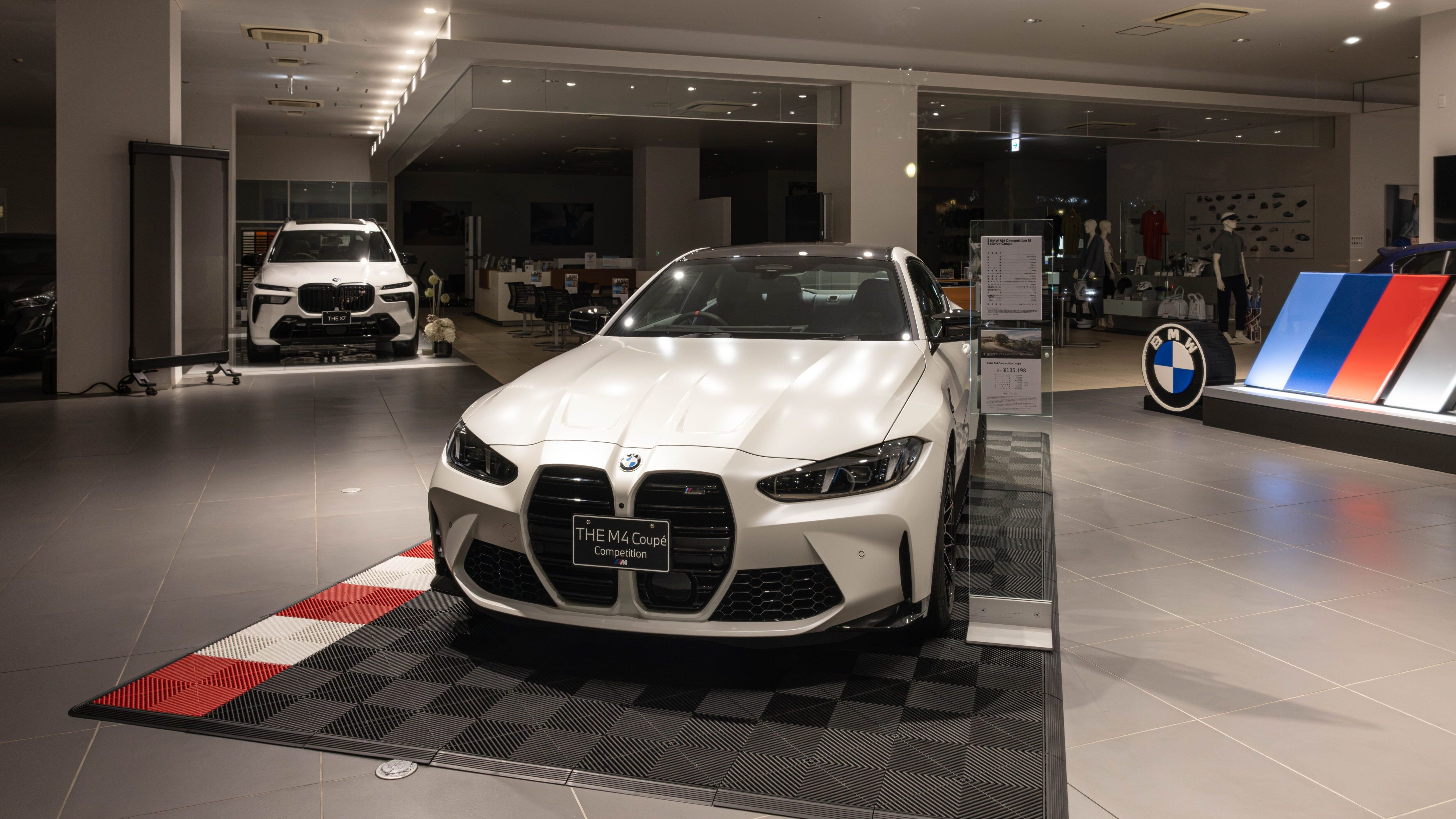 BMW M4 Competition Coupe on display inside a BMW dealership