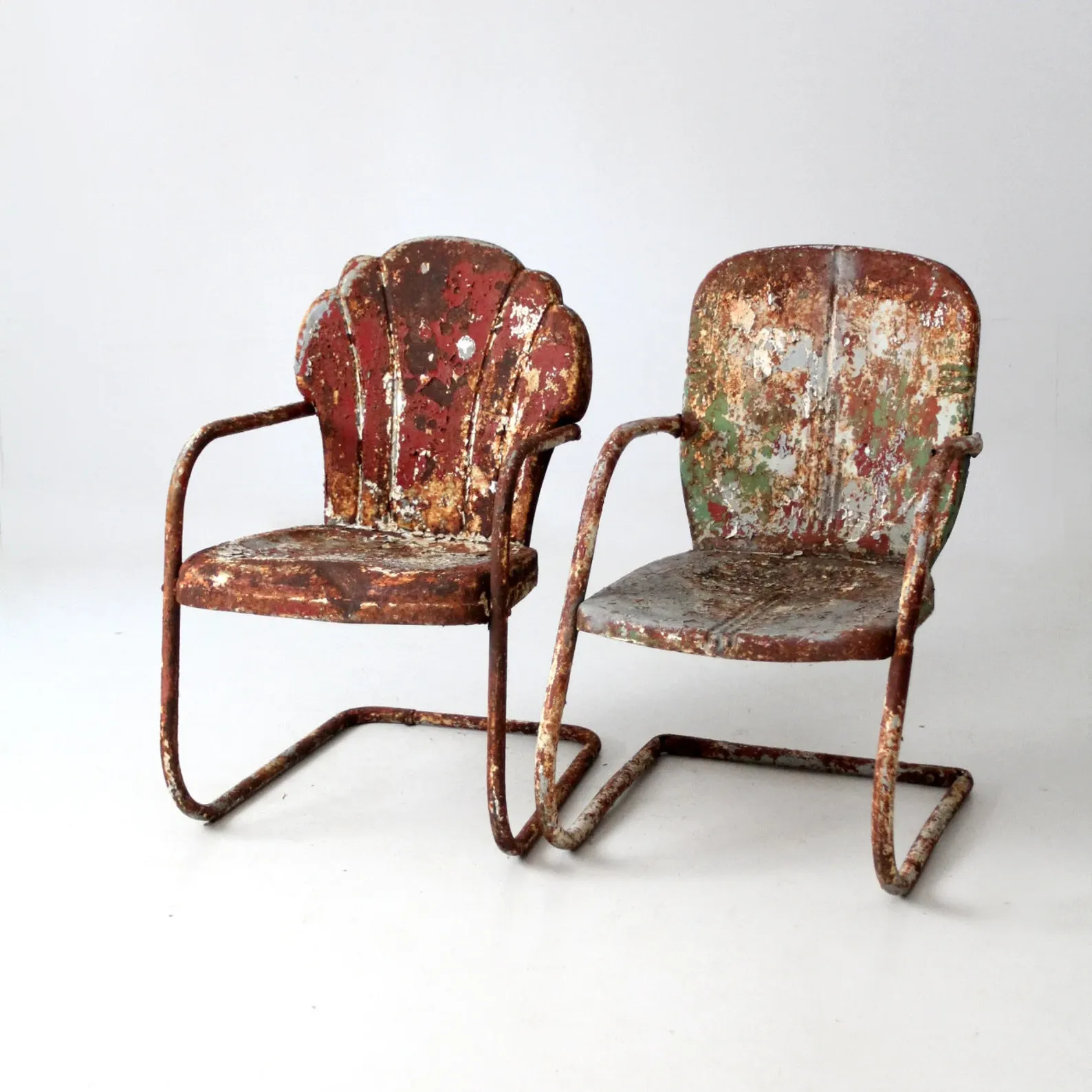 A pair of antique lawn chairs