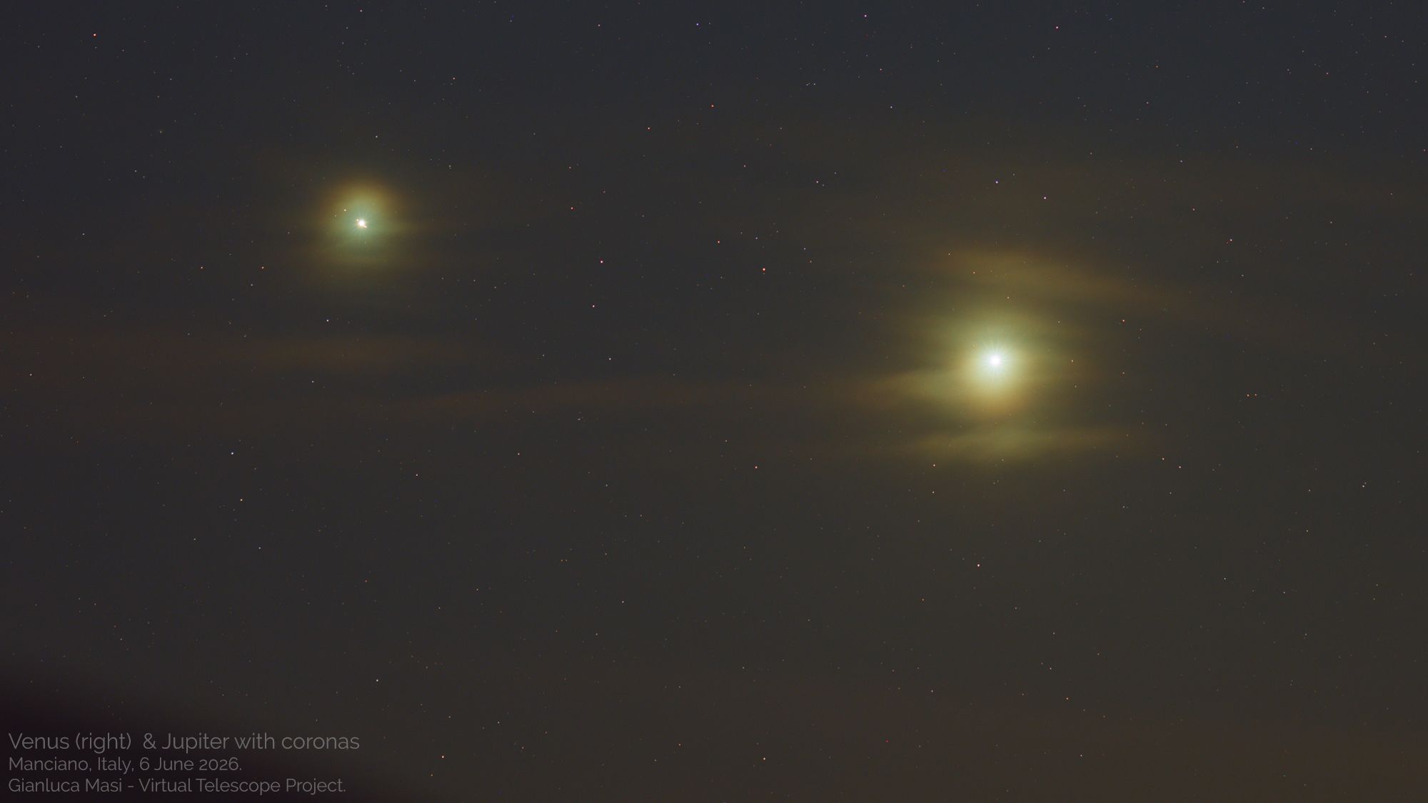Two bright planets are photographed shining side by side in the night sky, surrounded by diffuse glows and the sporadic lights of fainter stars.