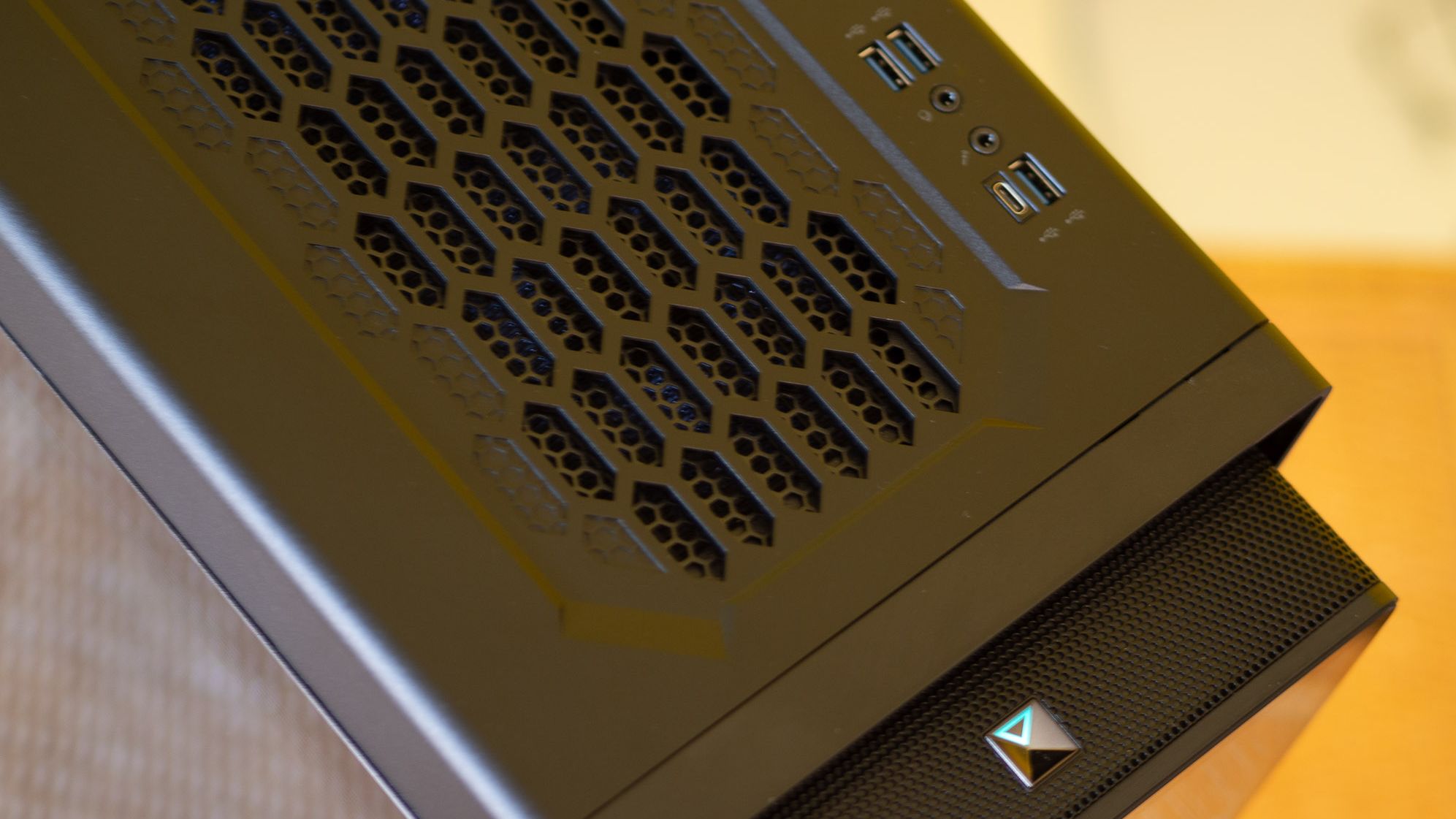 Acer Predator Orion 7000 gaming desktop PC on a wooden desk and yellow background