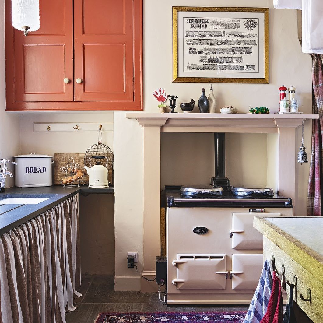 Country kitchen with AGA, rug and cupboard curtain