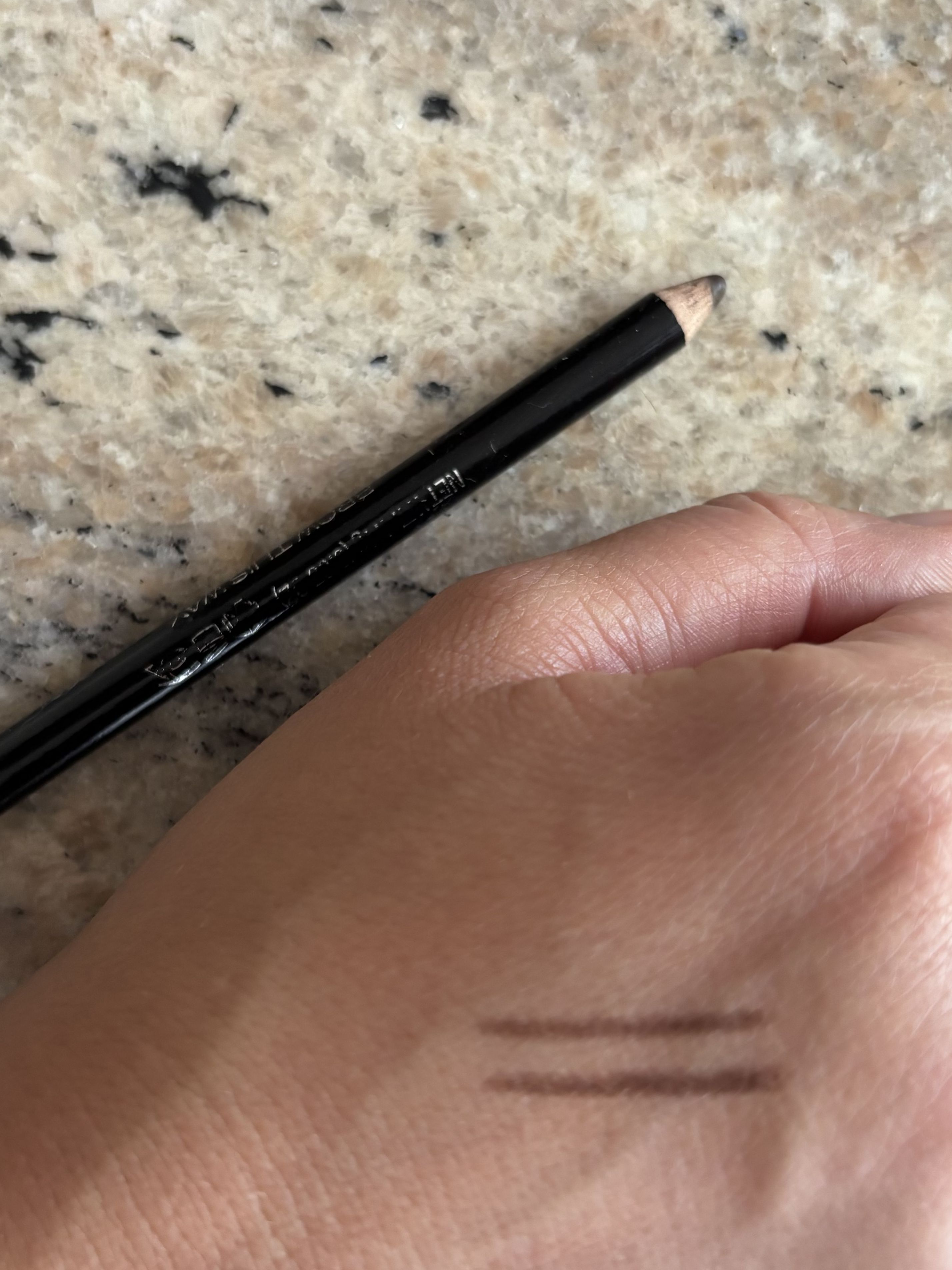 Beauty editor Perdita swatching the Rimmel Eye Brow Pencil on her hand
