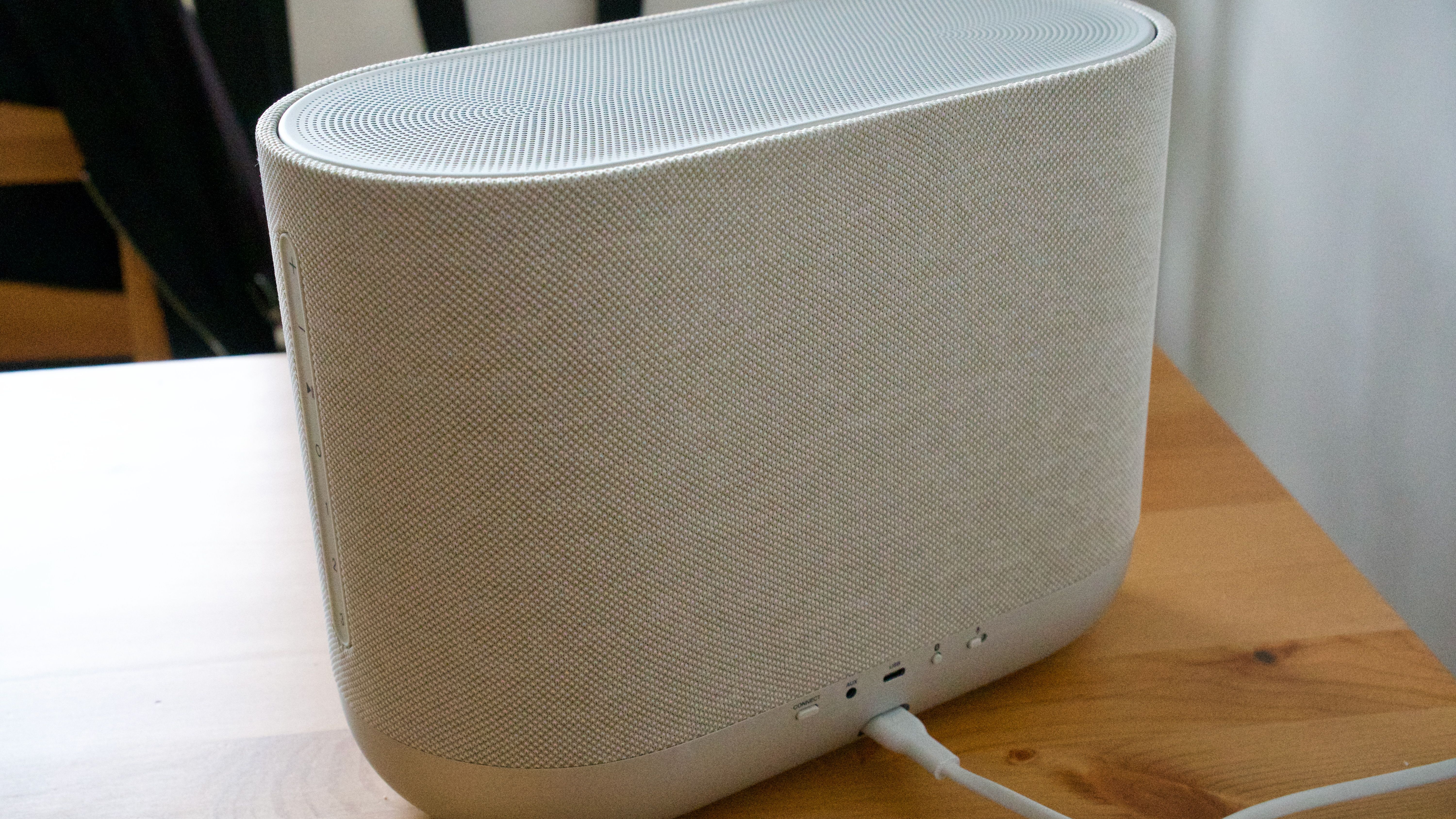Denon Home 400 home speaker rear panel, on a wooden surface