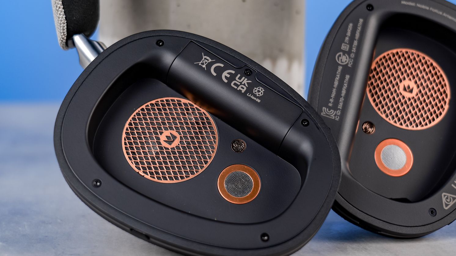 The Noble Audio FoKus Artemis with their earcups removed to show the drivers and removable battery