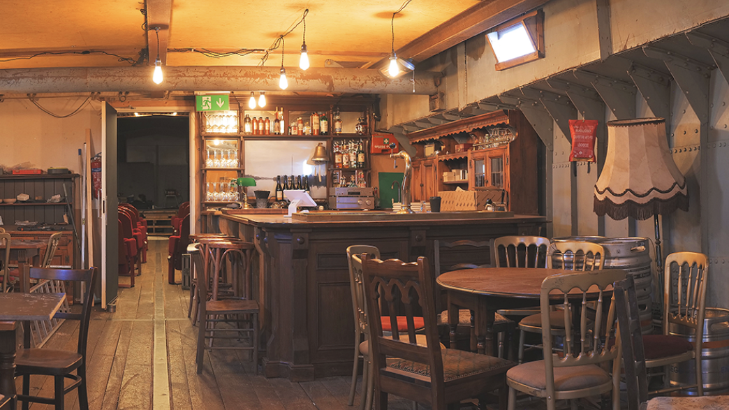 an image of the interior community bar and cafe space inside the old converted ship