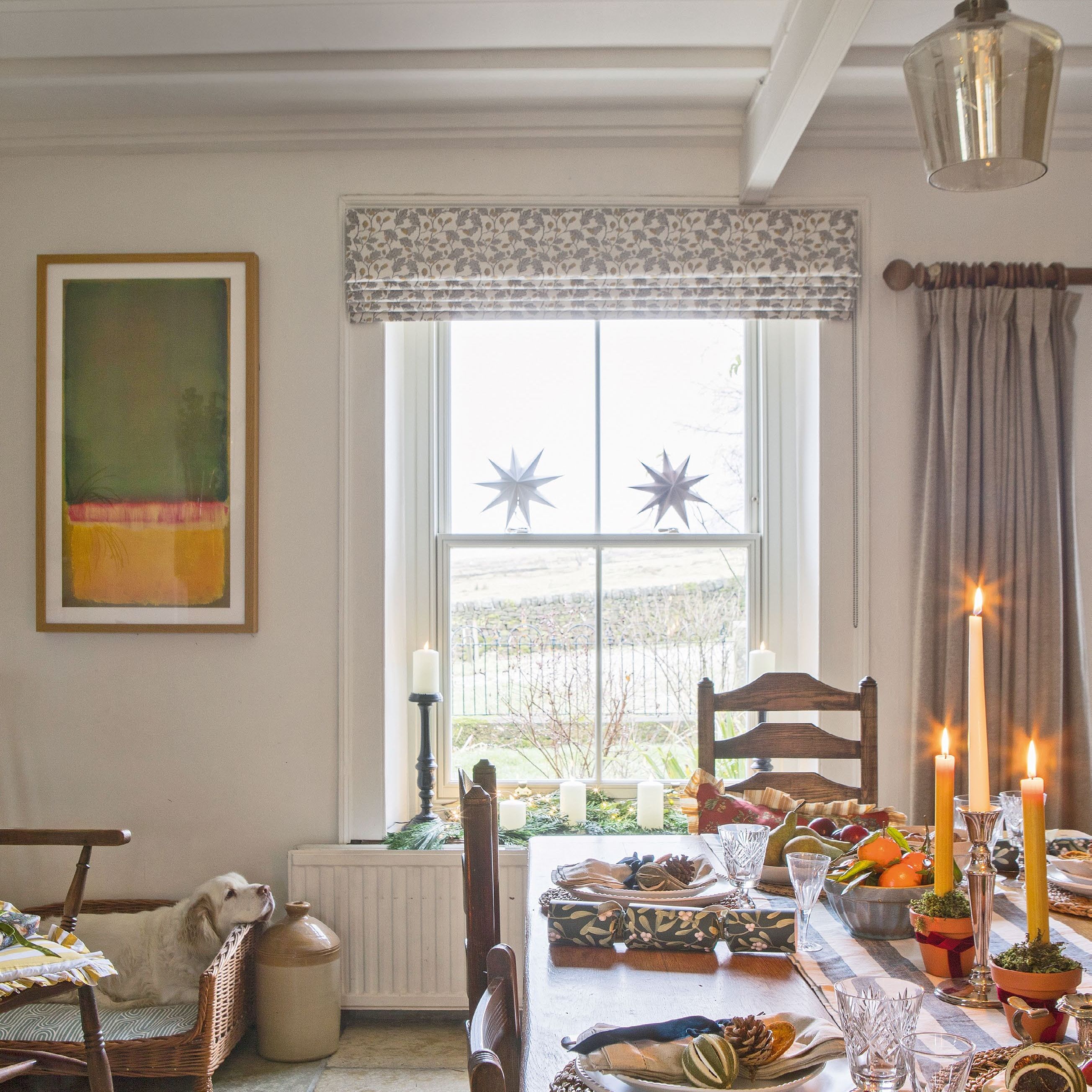 view towards window in country dining room with table dressed for Christmas