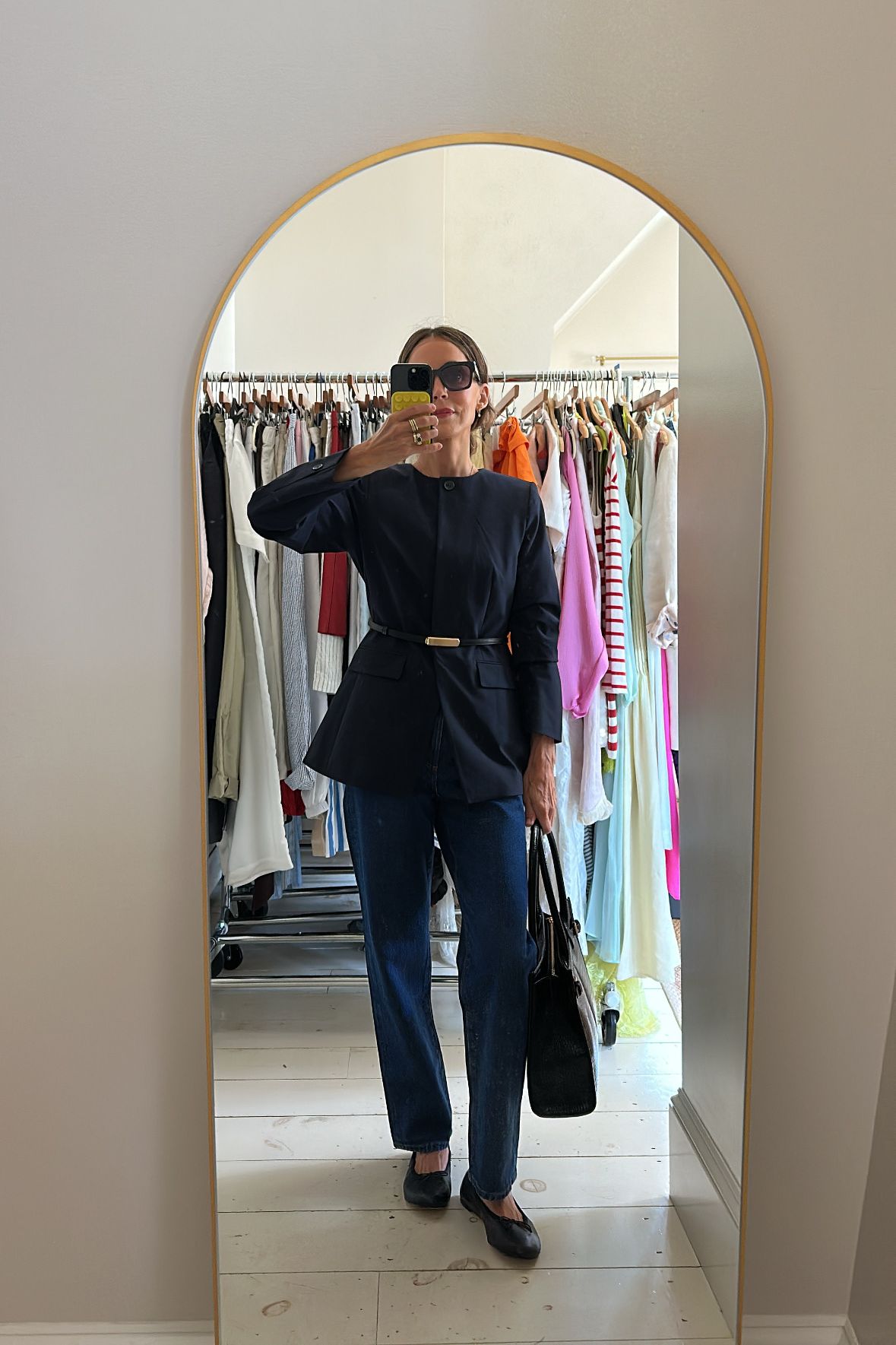 Larissa Mills wears jeans and a cinched jacket suited to petite sizing