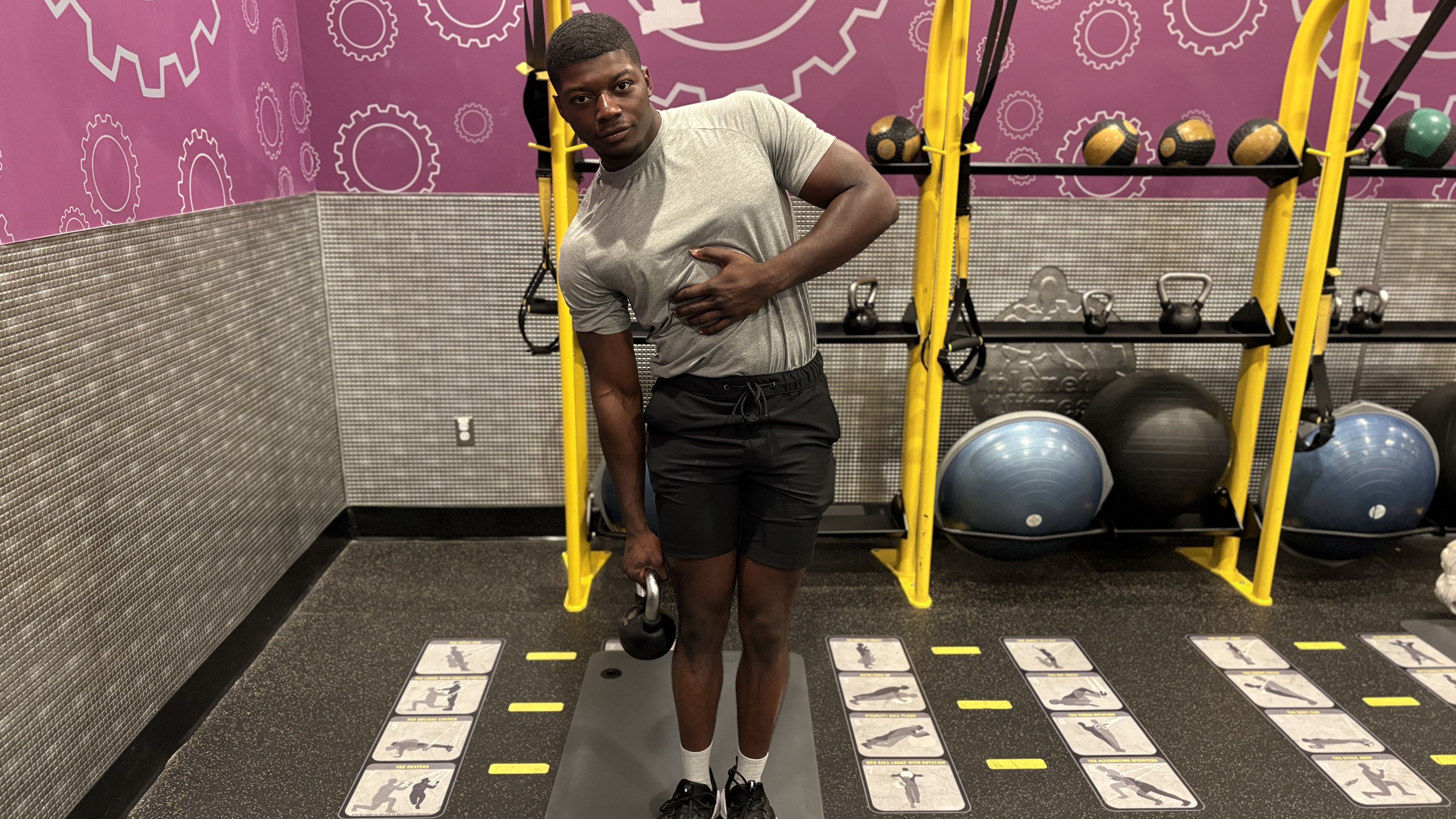 Man exercises with kettlebell in gym