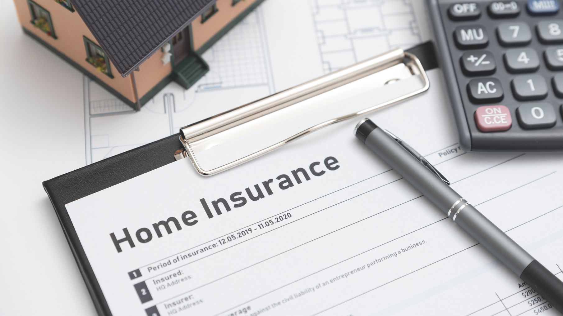 Home insurance form on the table. Assurance and home safety concept.