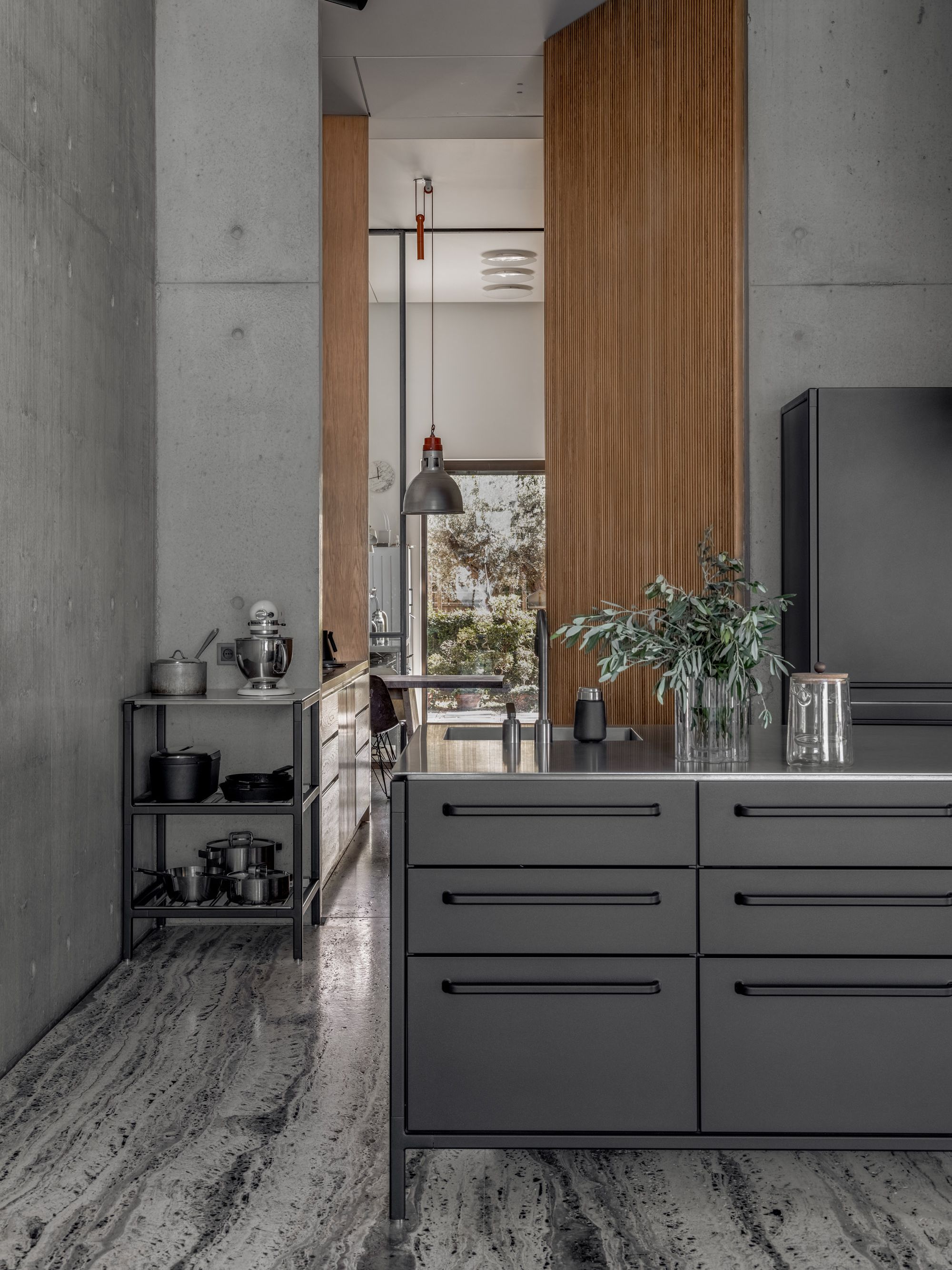 A black kitchen with wooden door