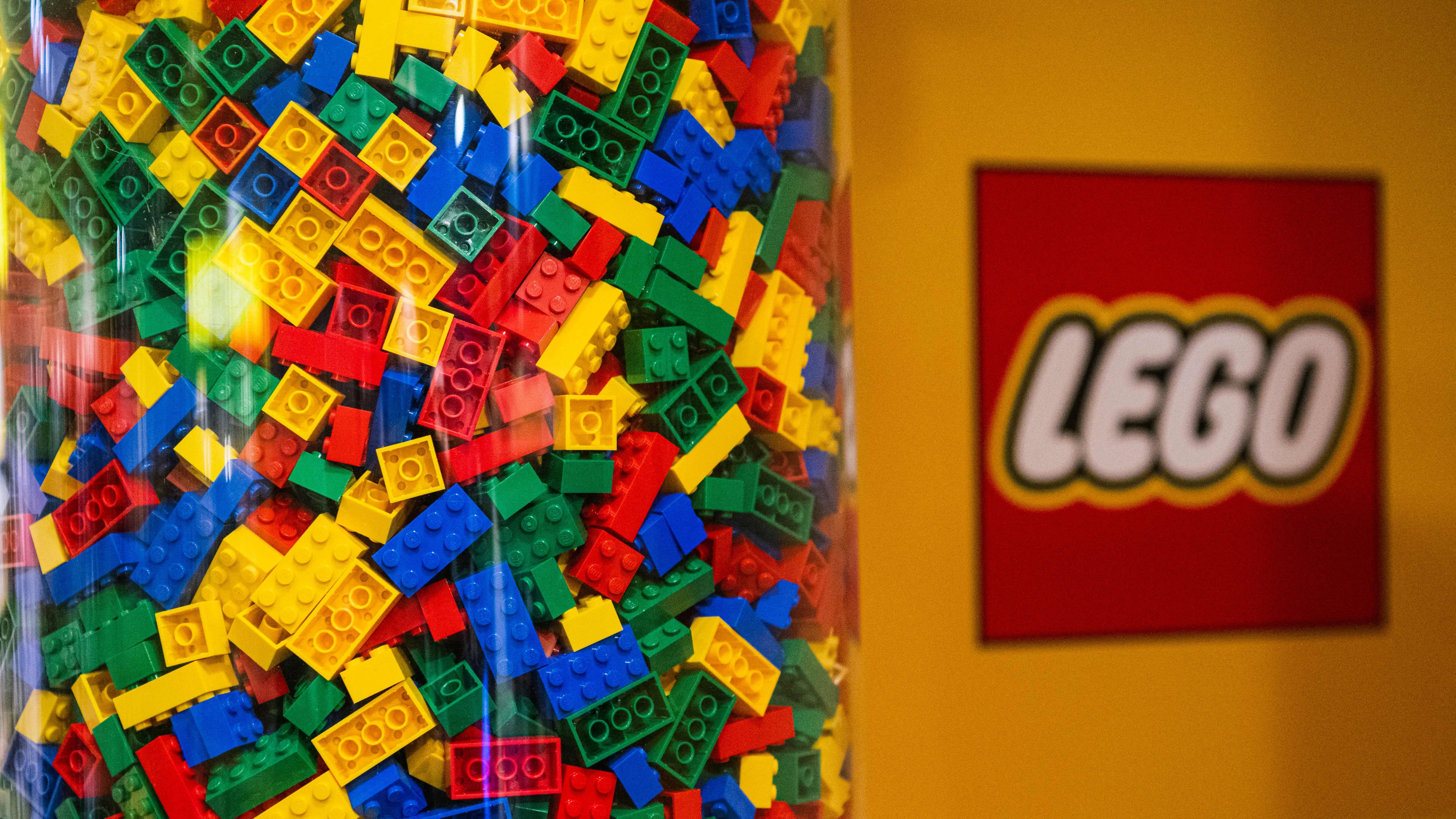 LEGO bricks are displayed next to a LEGO logo at a shop in the hotel LEGOLAND on November 29, 2022, in Billund, Denmark. (Photo by Jonathan NACKSTRAND / AFP) (Photo by JONATHAN NACKSTRAND/AFP via Getty Images)