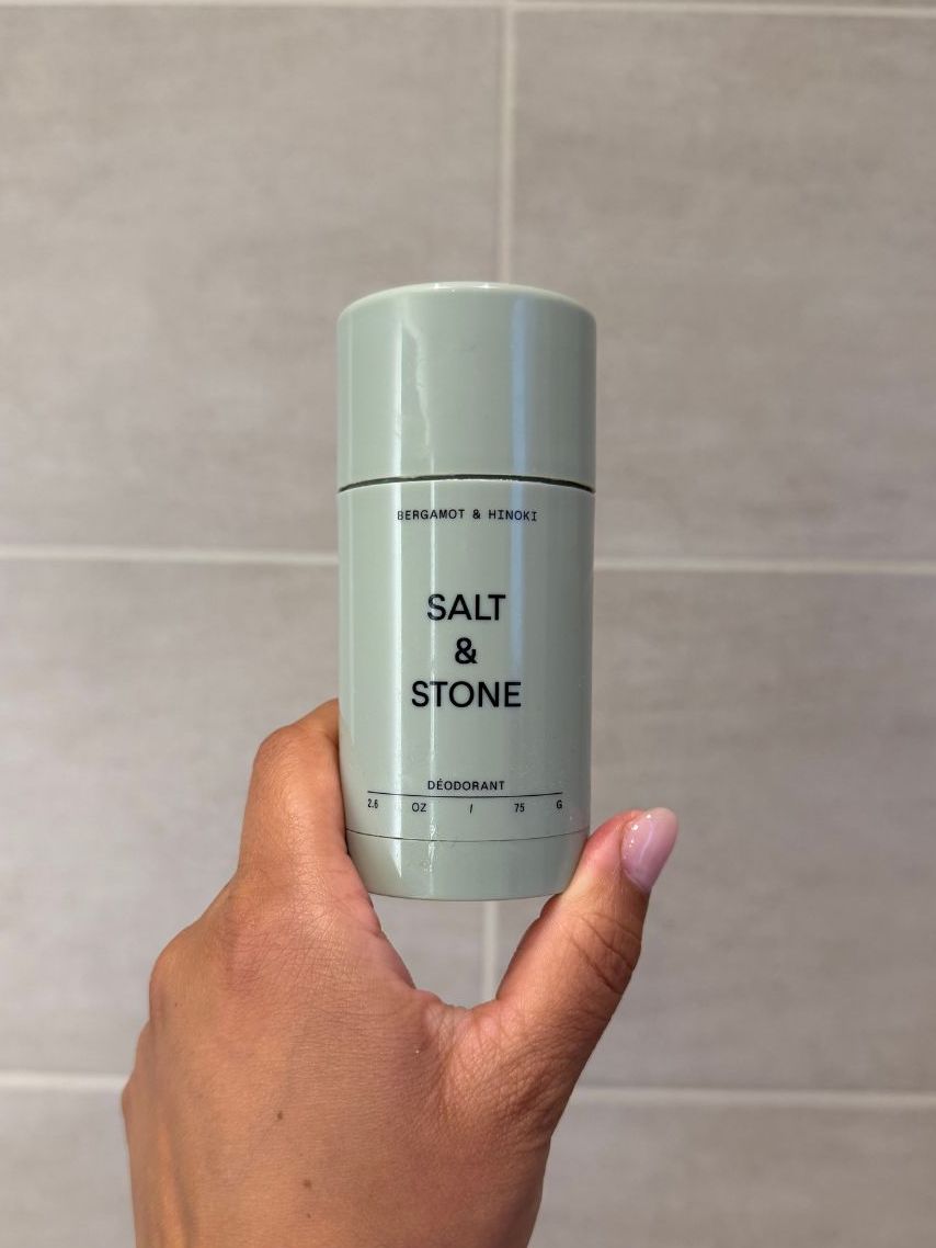 Aleesha holding empty Salt &amp;amp; Stone deodorant