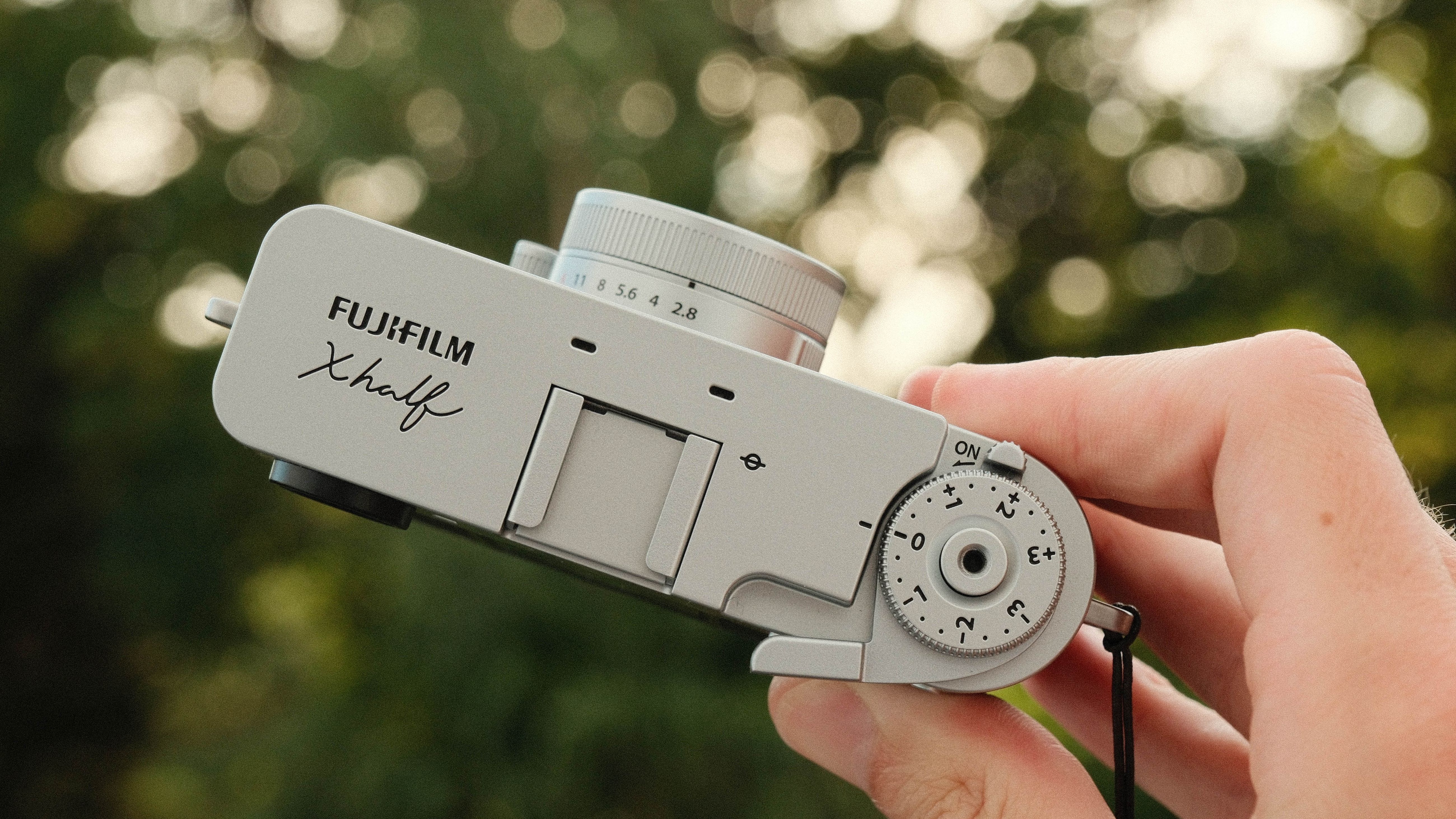 Fujifilm X Half camera held in a hand