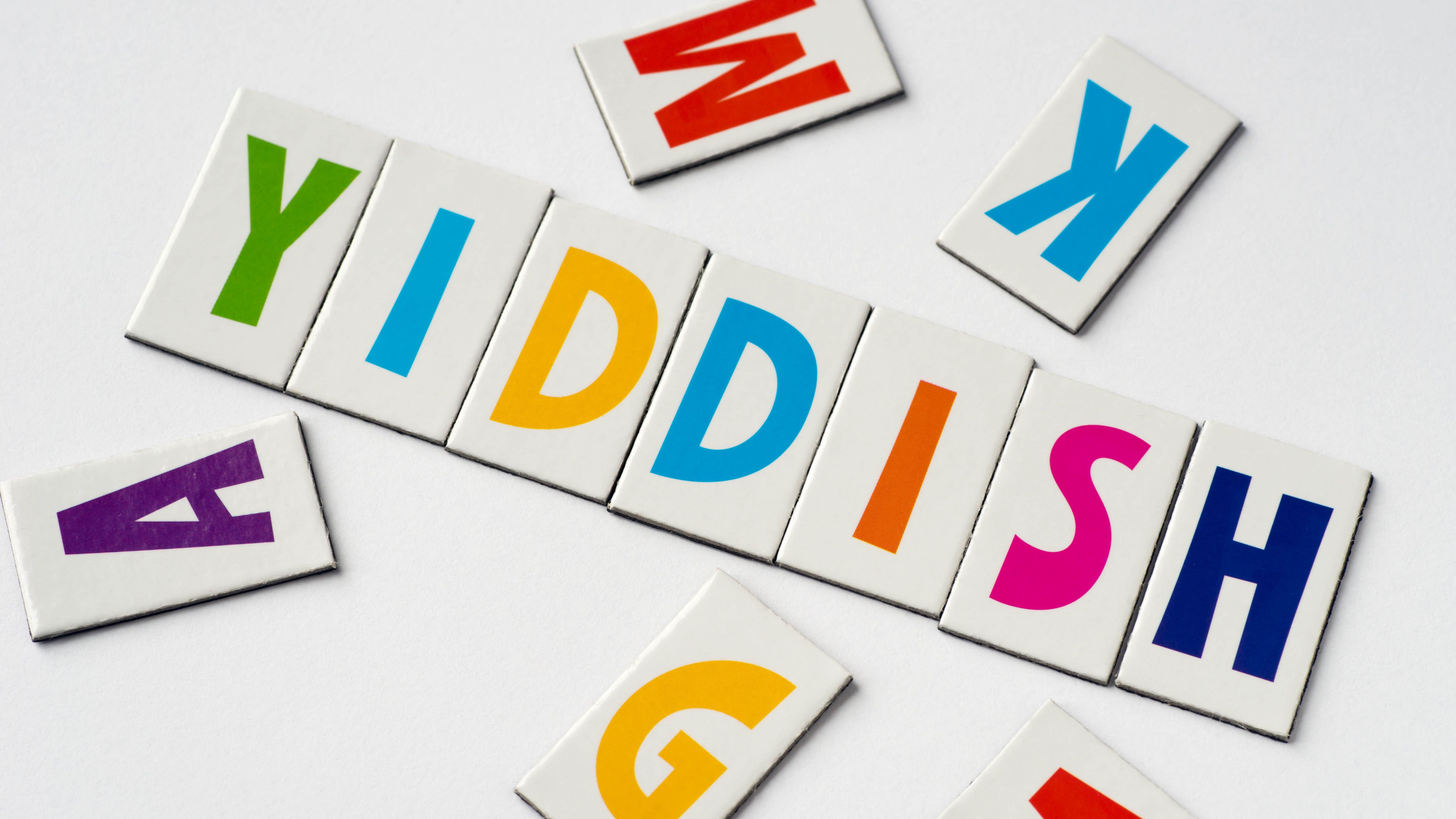 word Yiddish made of colorful letters on white background