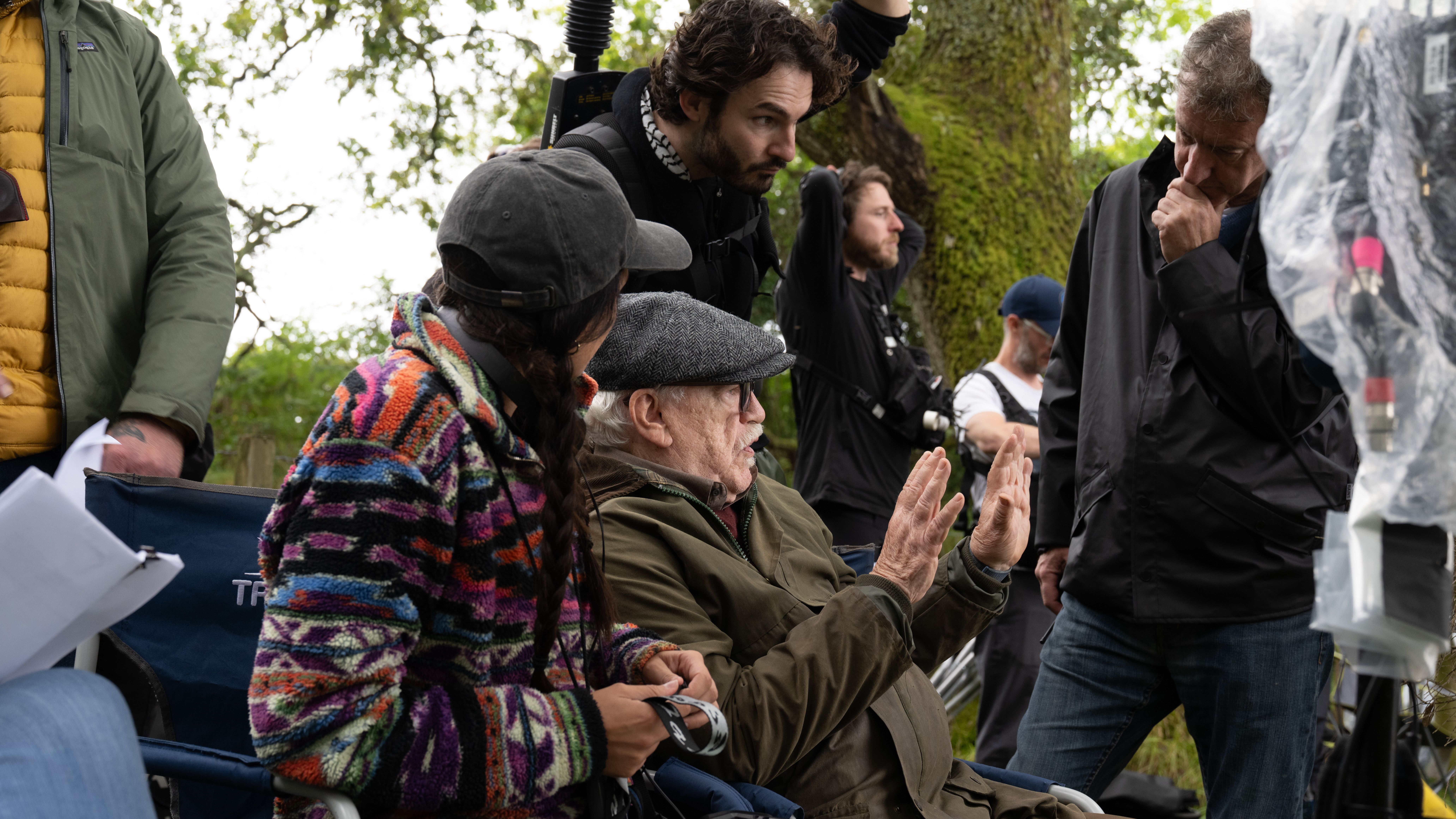 a BTS image of Brian Cox on the set of Glenrothan mid-discussion