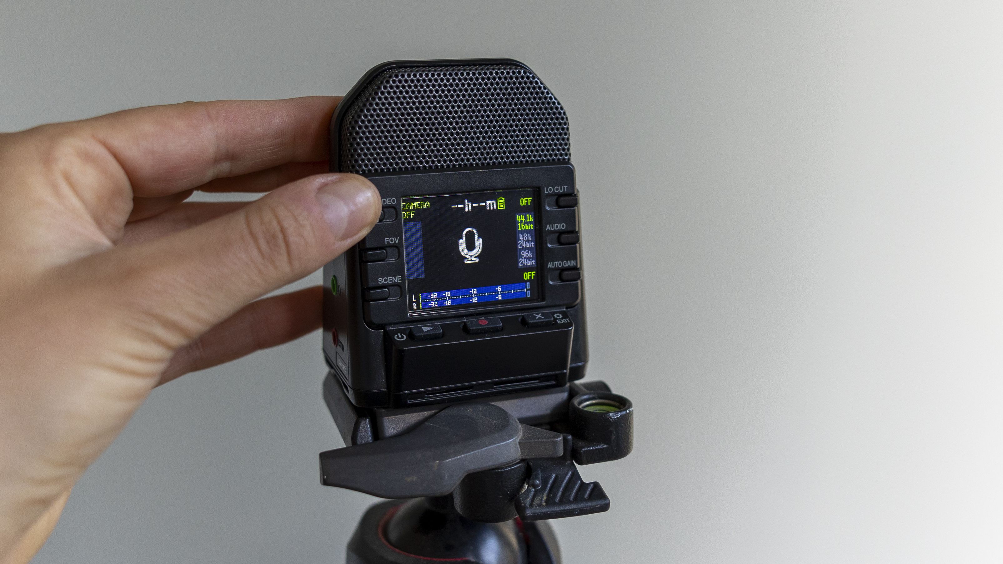The Zoom Q2N-4K recorder in a light studio against a green wall