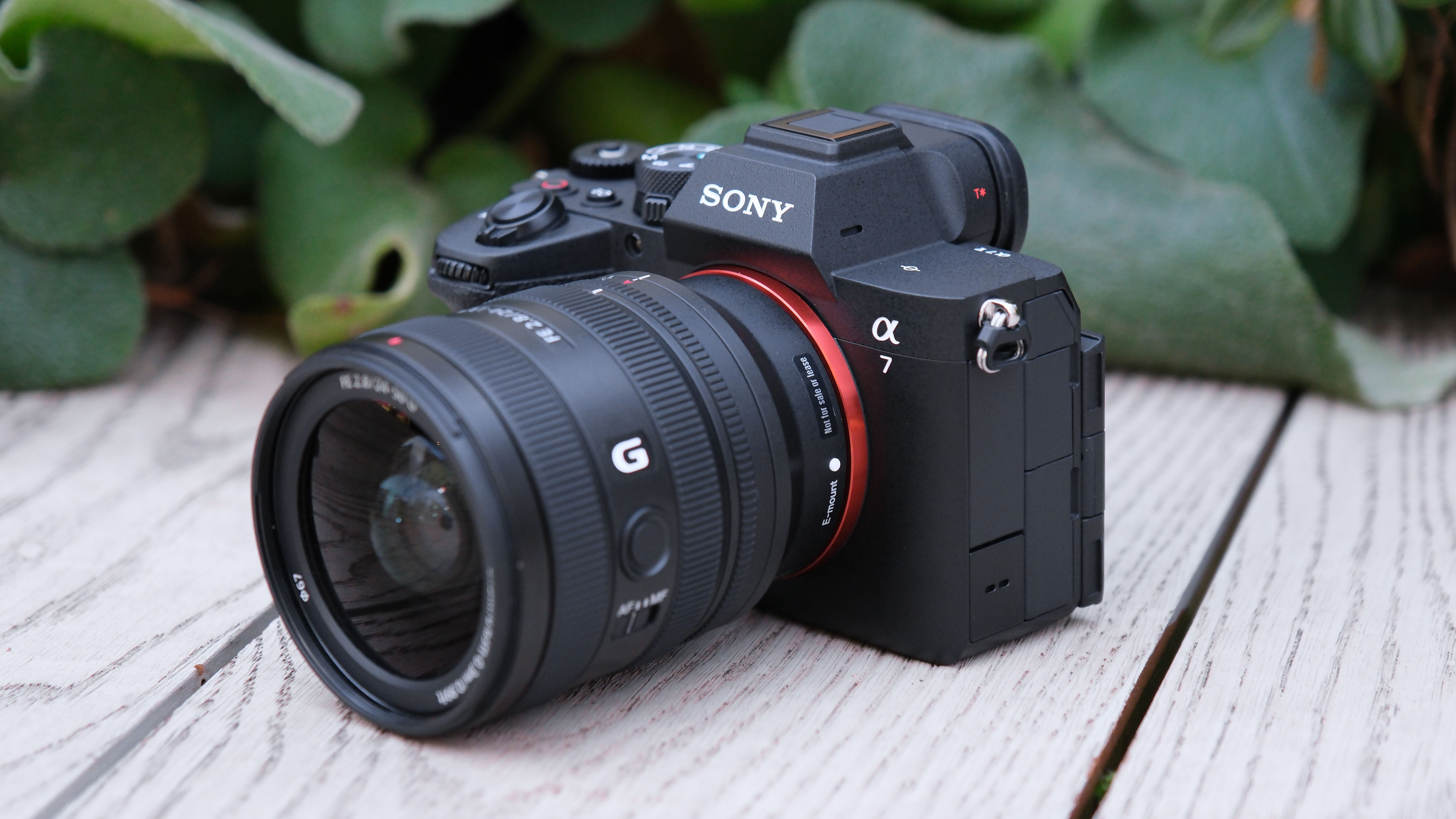 Sony A7 V camera with lens attached on a wooden surface