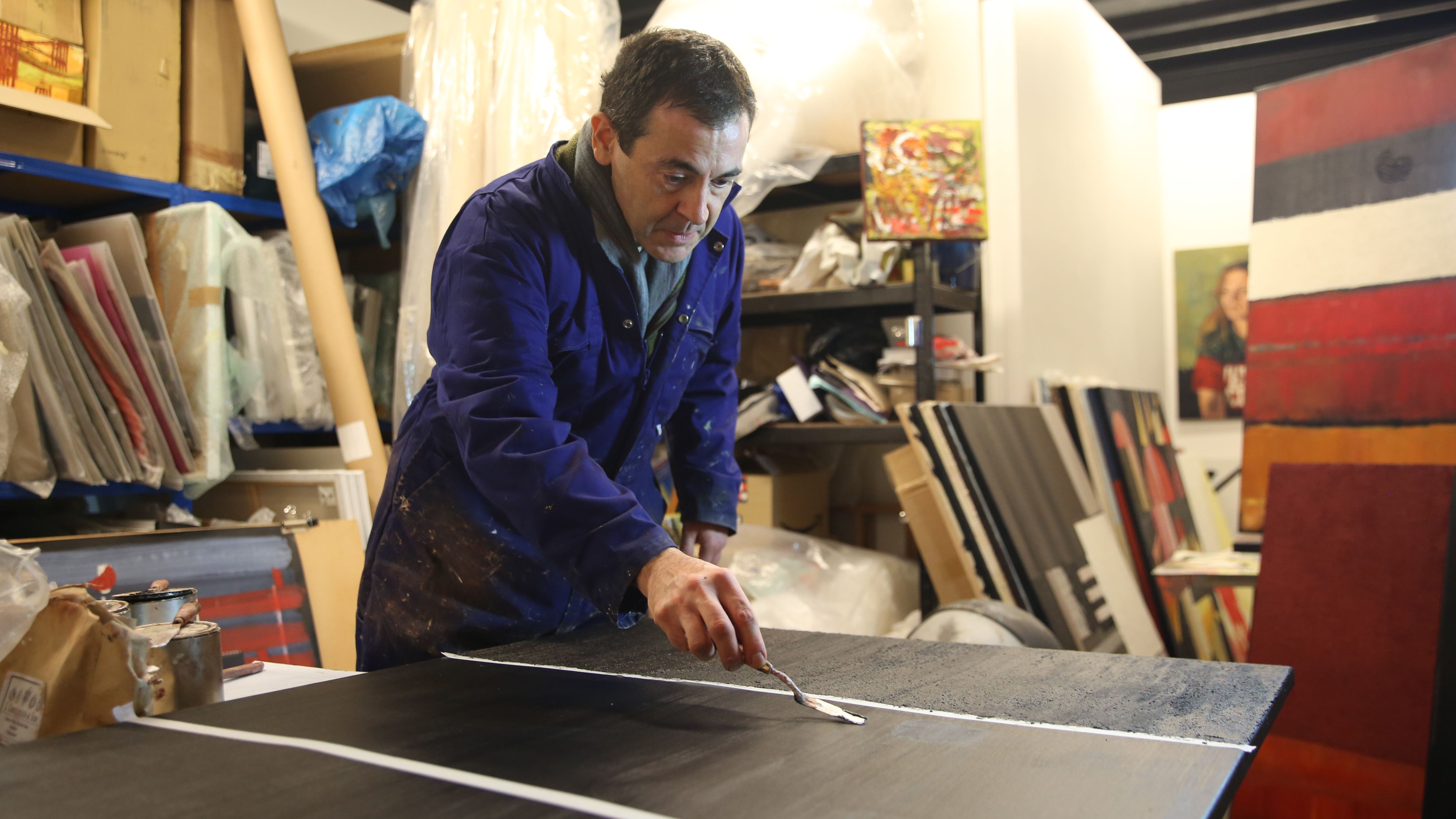 an image of a painter who is involved with Art On Our Doorstep: Croydon&amp;rsquo;s Contemporary Art Fair working on a piece at Turf Studio