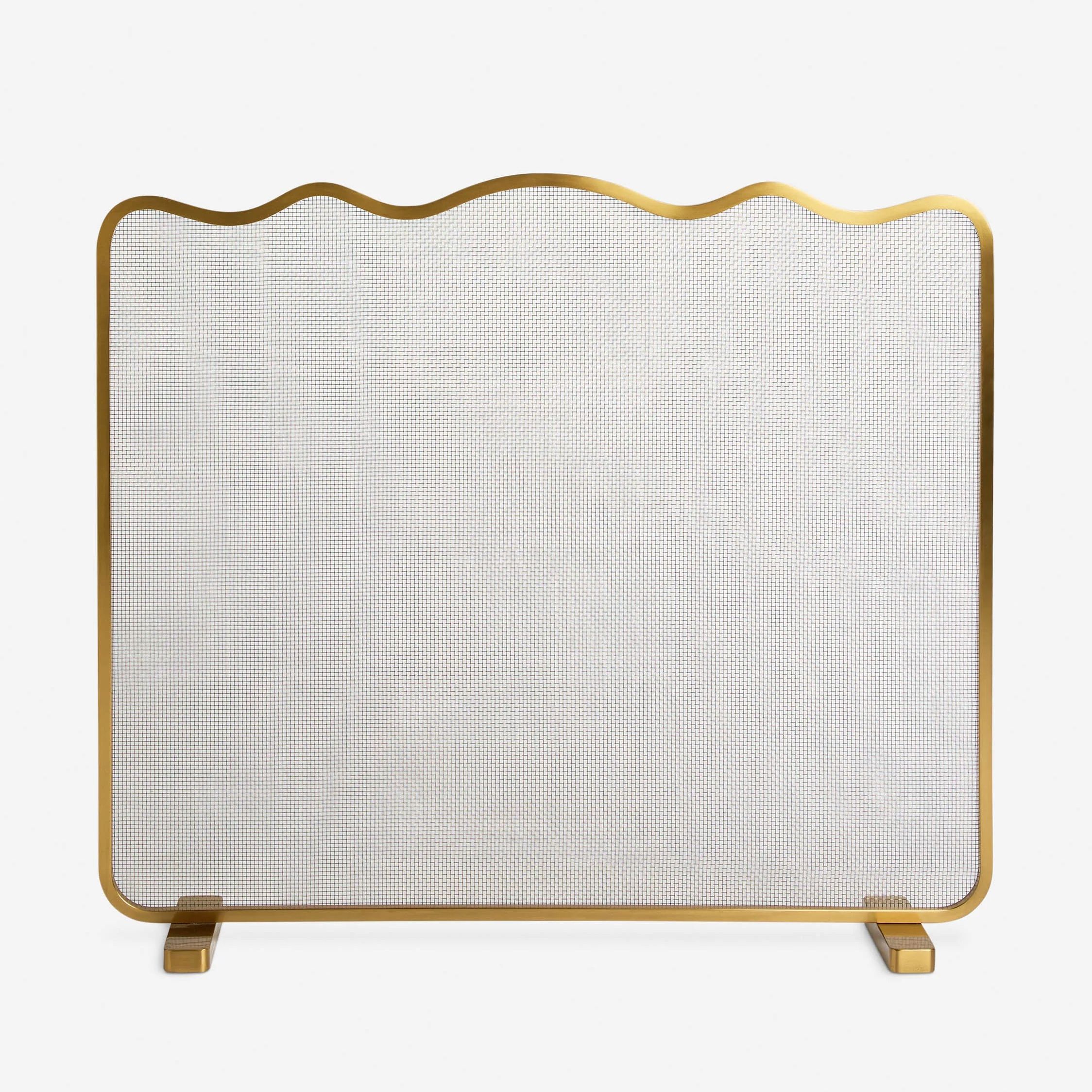 Brass fireplace screen with a softly scalloped top edge and fine mesh panel, supported by two matching brass feet.