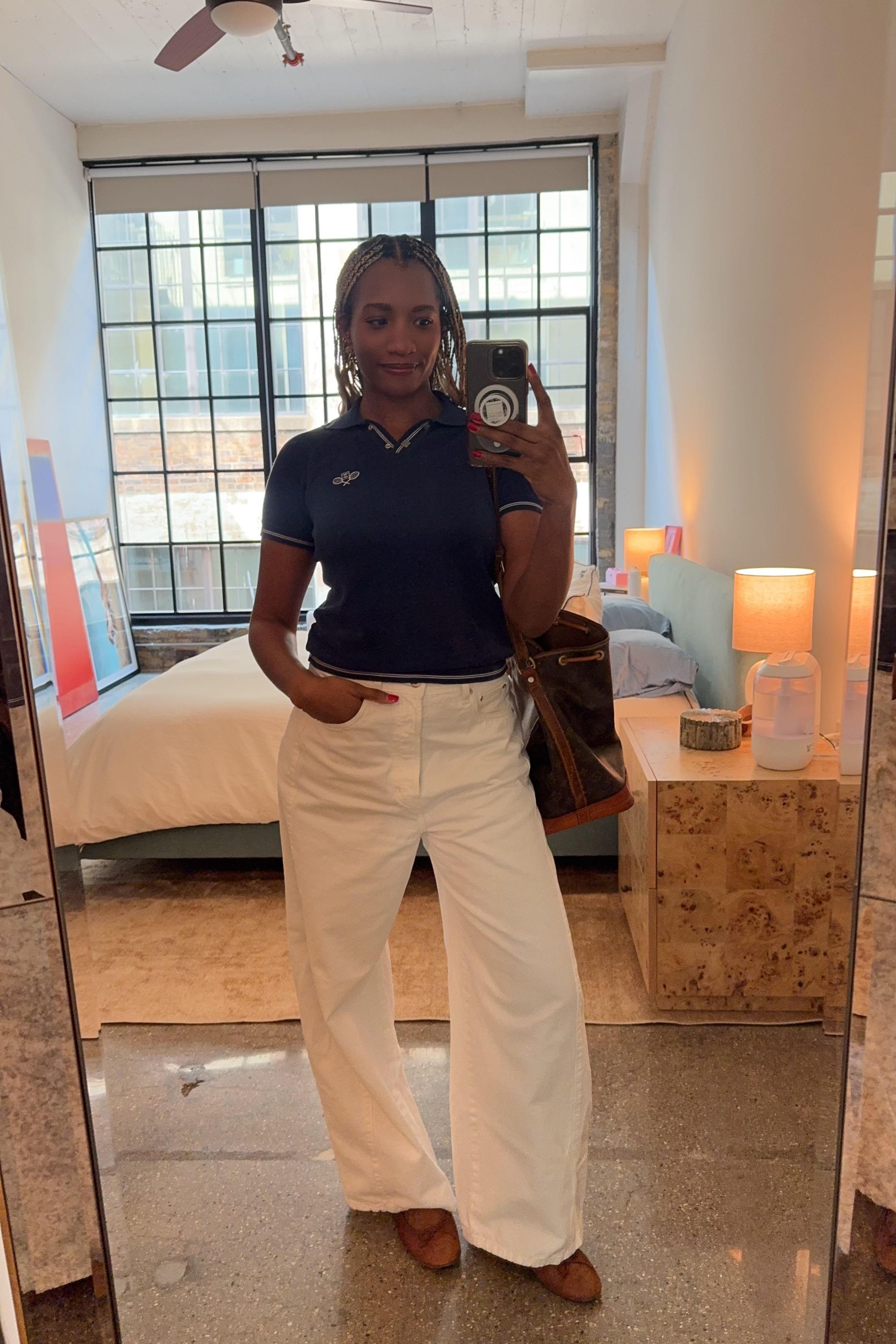 Danielle Prescod styles a polo shirt and white jeans with ballet flats and a Vuitton bag