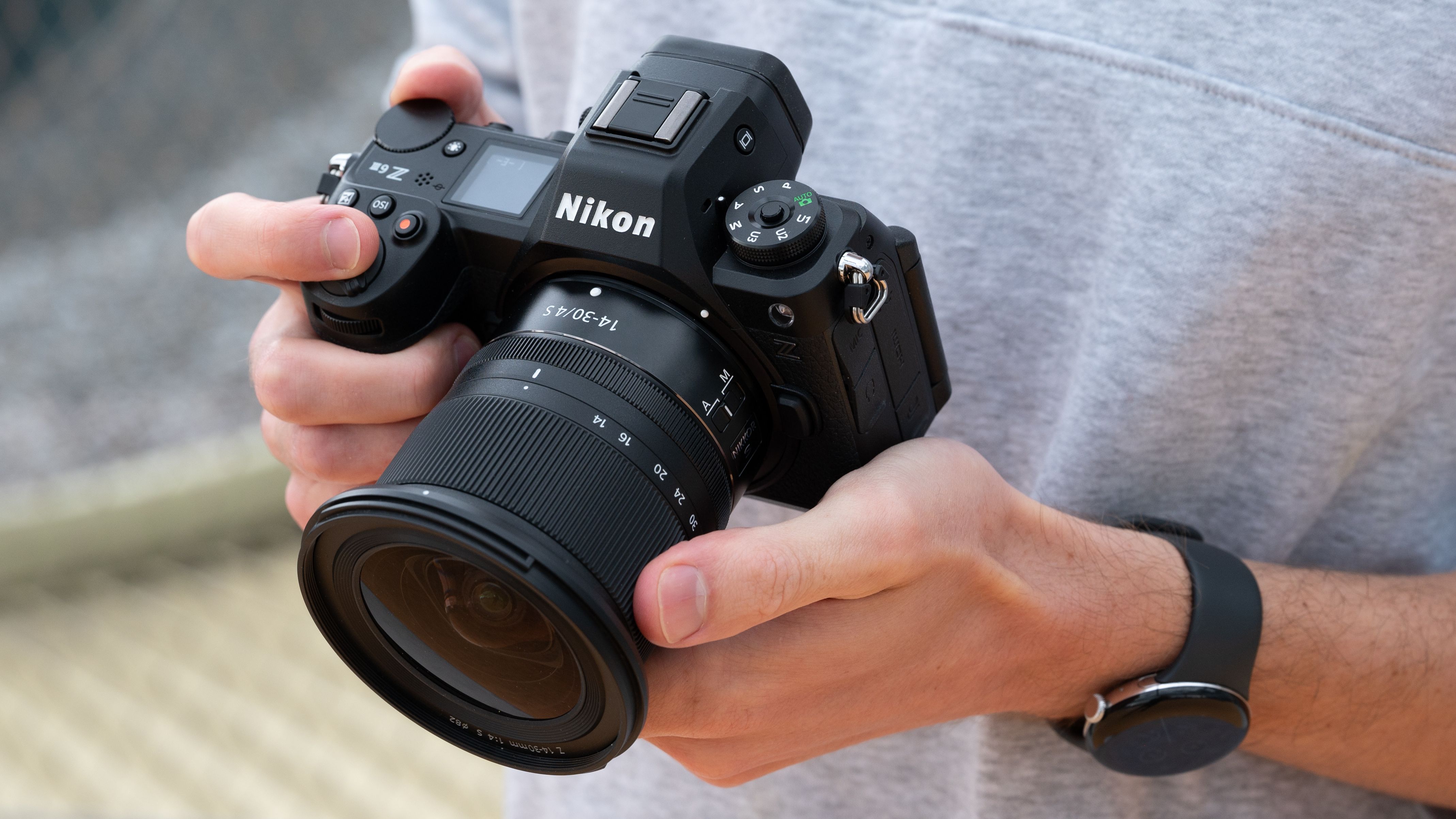 Nikon Z6 III camera held in a pair of hands