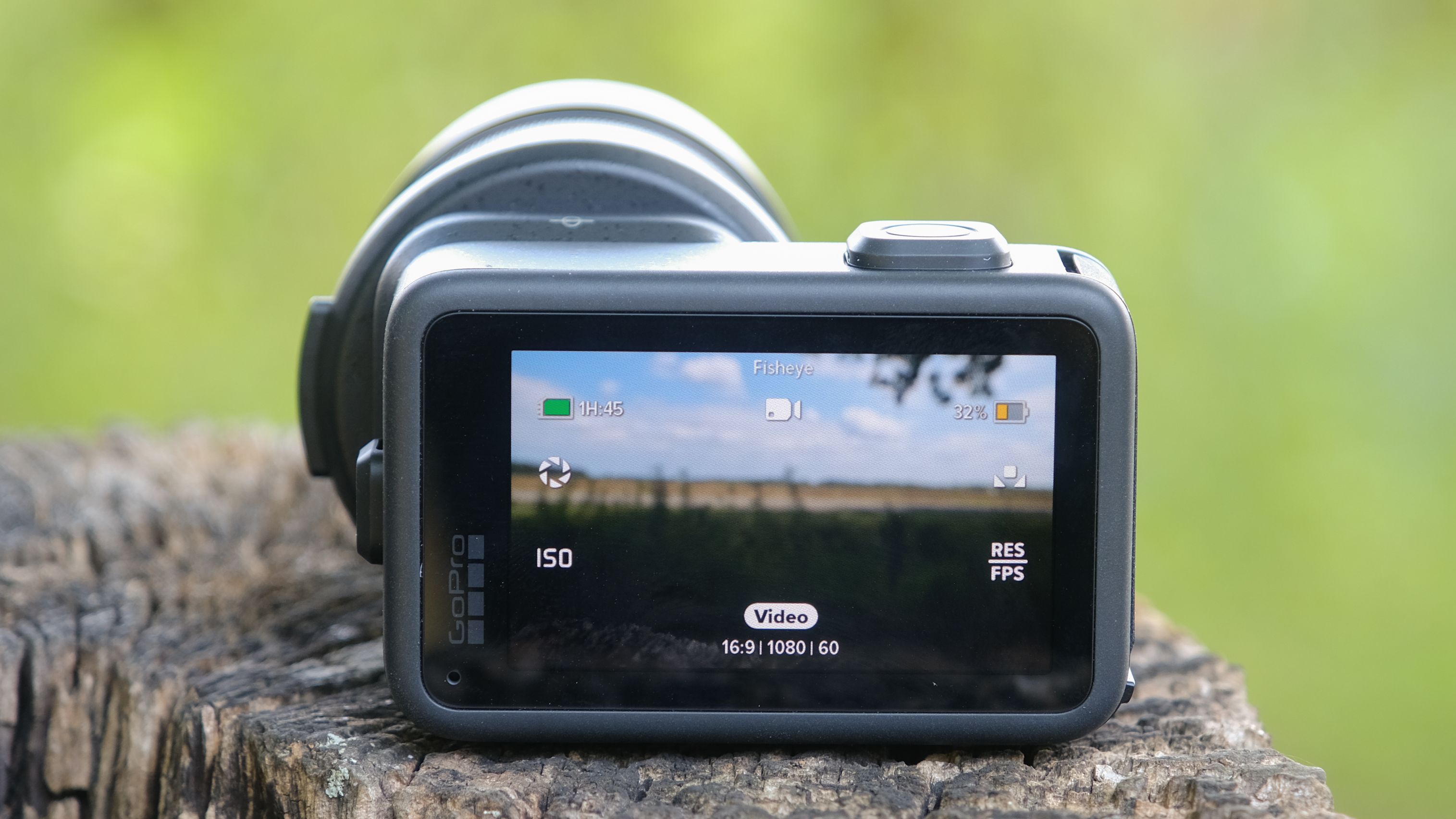 The GoPro Mission 1 ILS mirrorless camera photographed outdoors on a tree stump