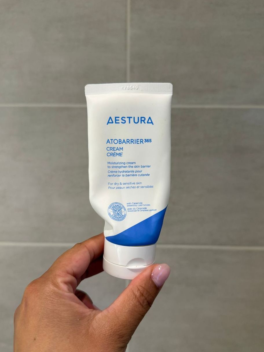 Aleesha holding empty Aestura Atobarrier Cream
