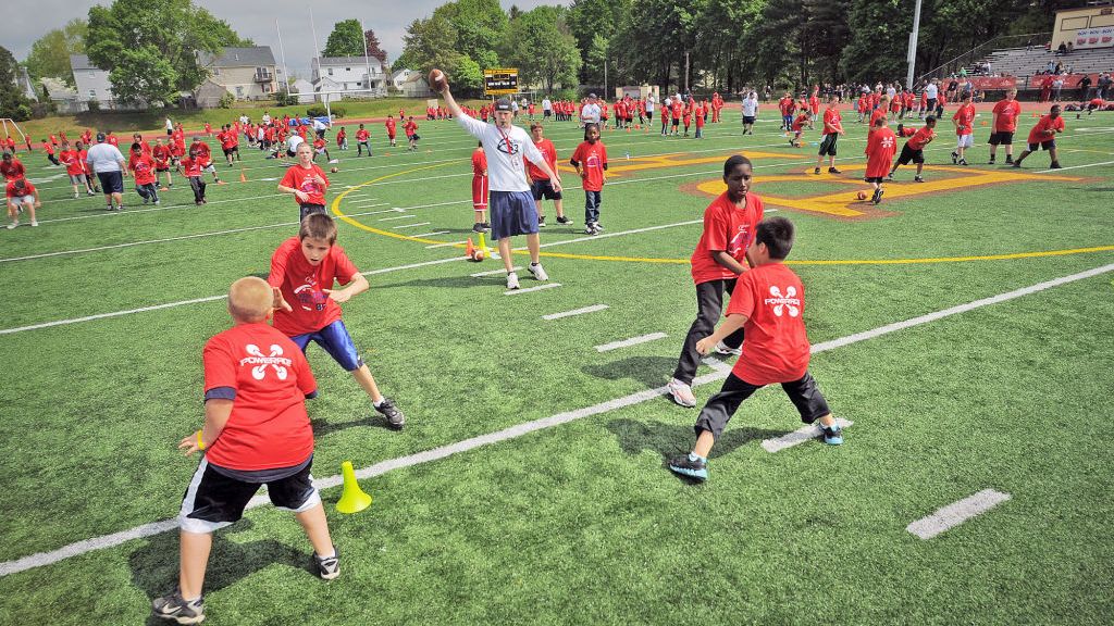 Peabody, MA -Establishing shot of young athletes at Patriots Wes Welker youth football camp at Bishop Fenwick High School