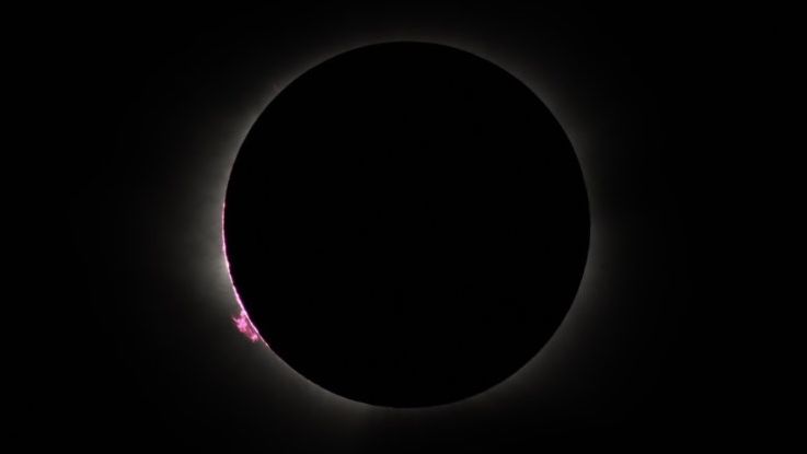 I sailed to Greenland for a total solar eclipse — what I saw left me speechless 7 MyCelestialApp close up view of the suns chromosphere appearing as a thin pink disk and a large prominence at the lower left corner