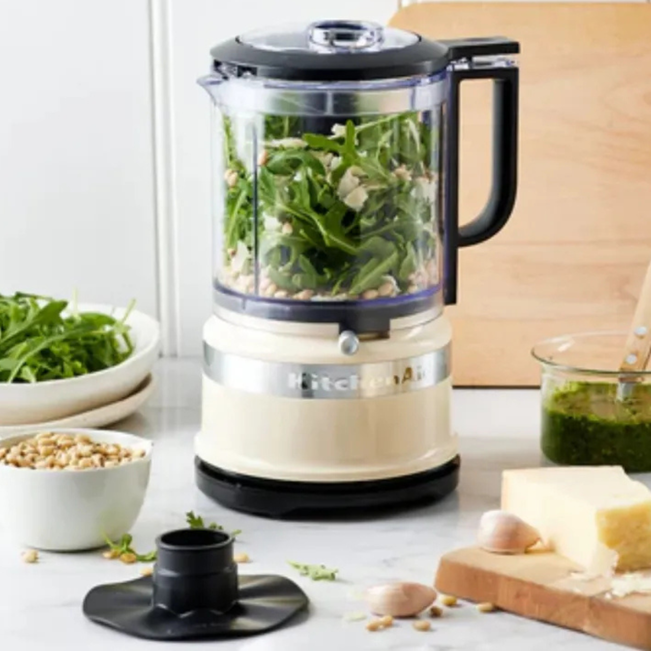 KitchenAid food chopper in cream, blending a fresh rocket pesto