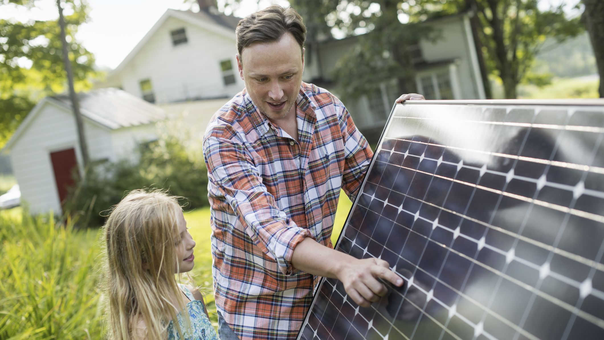 A father explaining how solar panels work to his daughter.